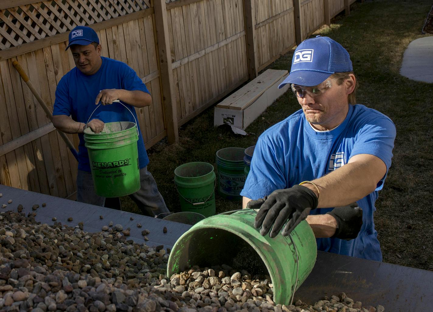 Robert Elsola shovels rocks into a bucket.] The rocks are placed around the perimeter of the basement, concrete is then placed on top. BRIDGET BENNETT SPECIAL TO THE STAR TRIBUNE &#x2022; bridget.bennett@startibune.com Thursday, April 2, 2015 at a home in the Seward neighborhood of Minneapolis, MN. They are installing a sump pump in the basement of the home. The rocks are placed around the perimeter of the basement, concrete is then placed on top. The sump basin is where the water is collected.