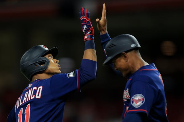orge Polanco, left, high-fives Tony Diaz, right, after hitting a three-run home run during the ninth inning.