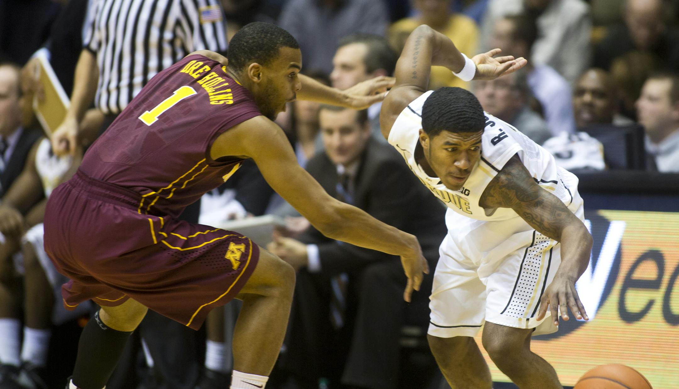 Minnesota's Andre Hollins, left, has the ball knocked out of his hands by Purdue's Ronnie Johnson during an NCAA college basketball game Wednesday, Feb. 5, 2014, at Mackey Arena in West Lafayette, Ind. (AP Photo/Journal & Courier, Michael Heinz) NO SALES