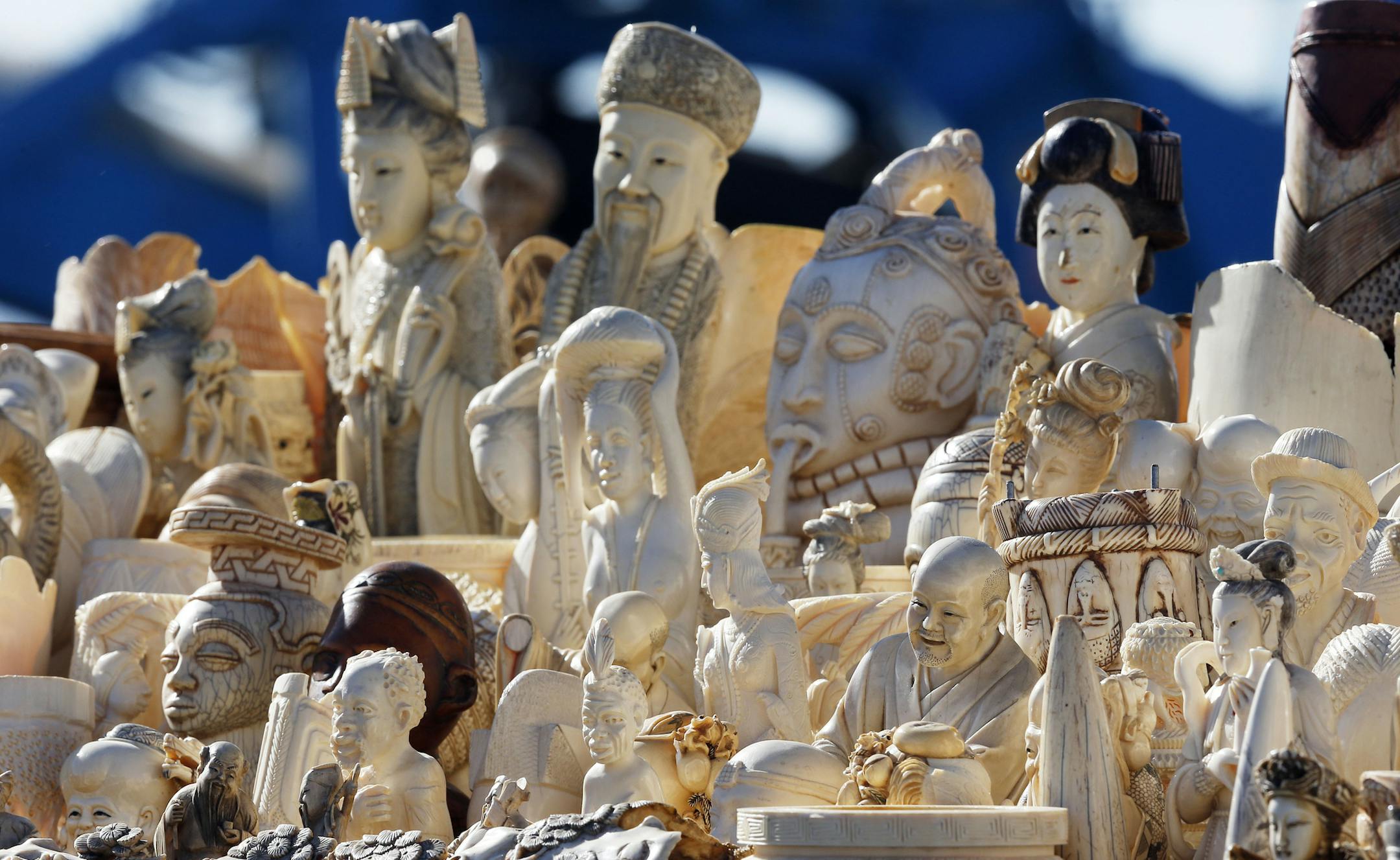 FILE - This Nov. 14, 2013 file photo shows confiscated decorative ivory piled together in preparation to be destroyed during an event at the National Wildlife Property Repository at Rocky Mountain Arsenal National Wildlife Refuge in Commerce City, Colo. The US is cracking down on the sale and purchase of ivory in hopes of curbing illicit poaching that's threatening to wipe out elephants and other species in Africa. The ivory ban is a key component of a new, national strategy for combating wildli