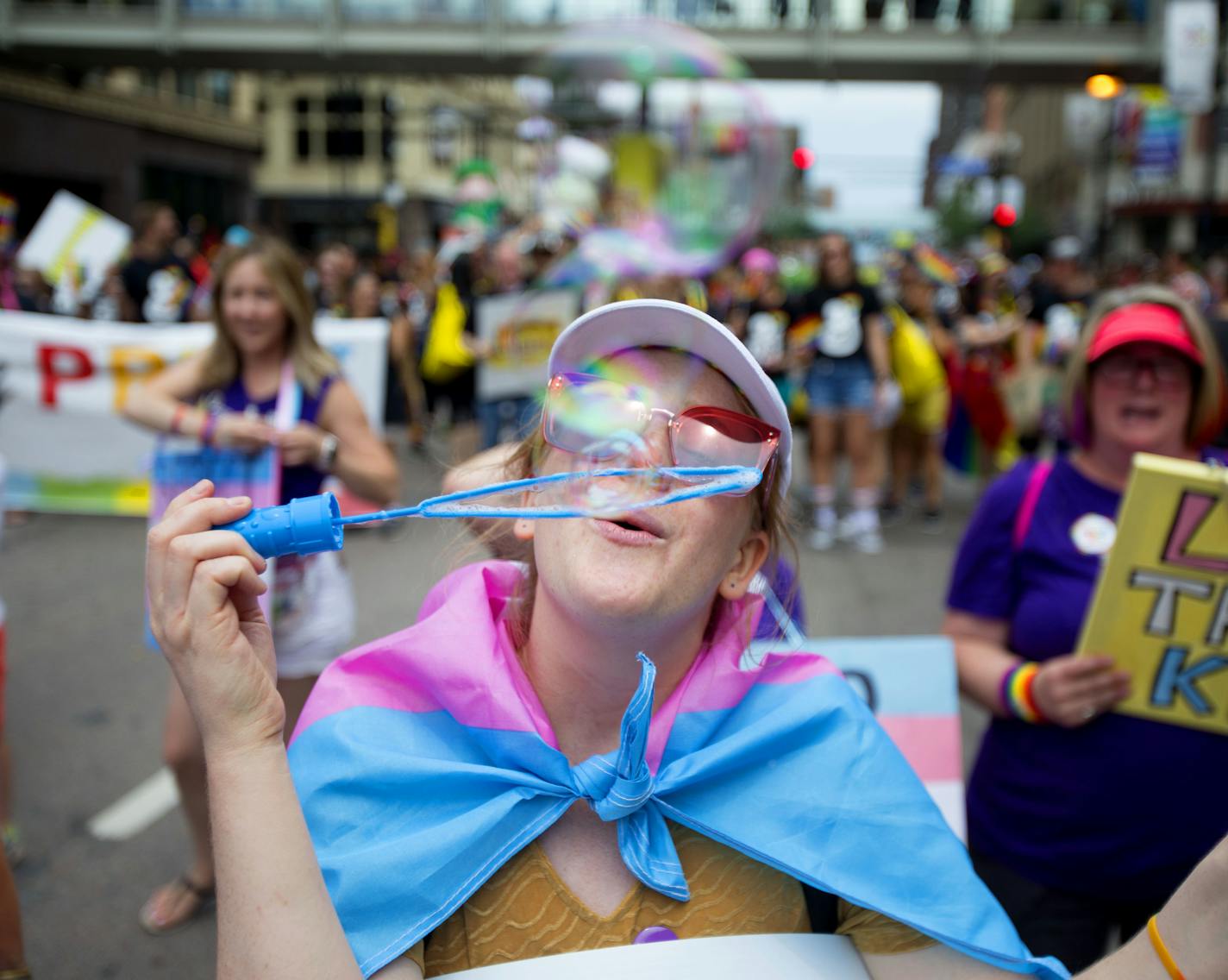 Anna Bey blows bubbles as they march down Hennepin on Sunday. ] ALEX KORMANN &#x2022; alex.kormann@startribune.com Hundreds of thousands of people gathered on Hennepin Avenue for the annual Pride Parade on Sunday. People of all age, shapes and sizes lined the street to celebrate love and all it's forms. Dozens of local businesses and organizations marched in the parade, all showing support for the LGTBQ community.