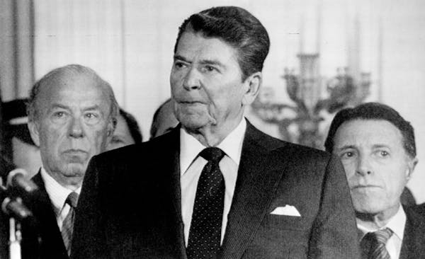 President Ronald Reagan with Secretary of State George Shultz, left, and Defense Secretary Caspar Weinberger in 1986.