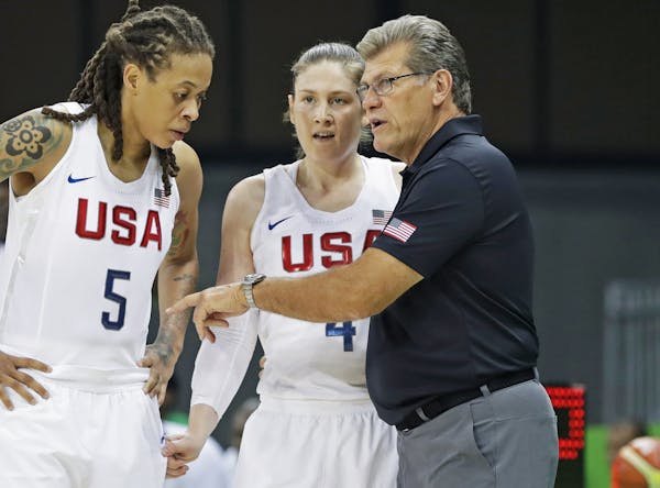 United States forward Seimone Augustus (5) and guard Lindsay Whalen listen to head coach Geno Auriemma during the second half of a women's basketball 