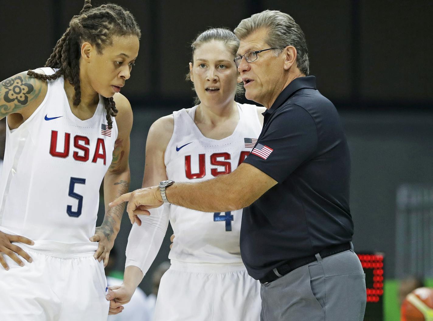 United States forward Seimone Augustus (5) and guard Lindsay Whalen listen to head coach Geno Auriemma during the second half of a women's basketball game against Senegal at the Youth Center at the 2016 Summer Olympics in Rio de Janeiro, Brazil, Sunday, Aug. 7, 2016. The United States defeated Senegal 121-56. (AP Photo/Carlos Osorio)