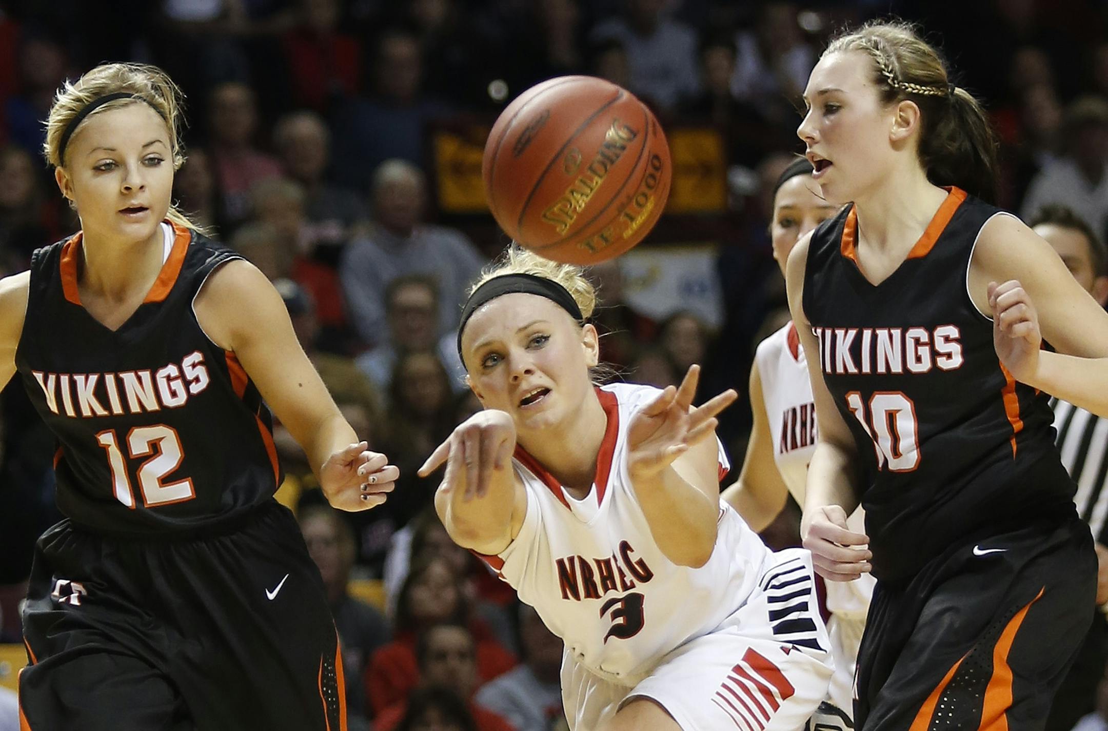 Carlie Wagner passed the ball between two Pelican Rapids players during the first half
