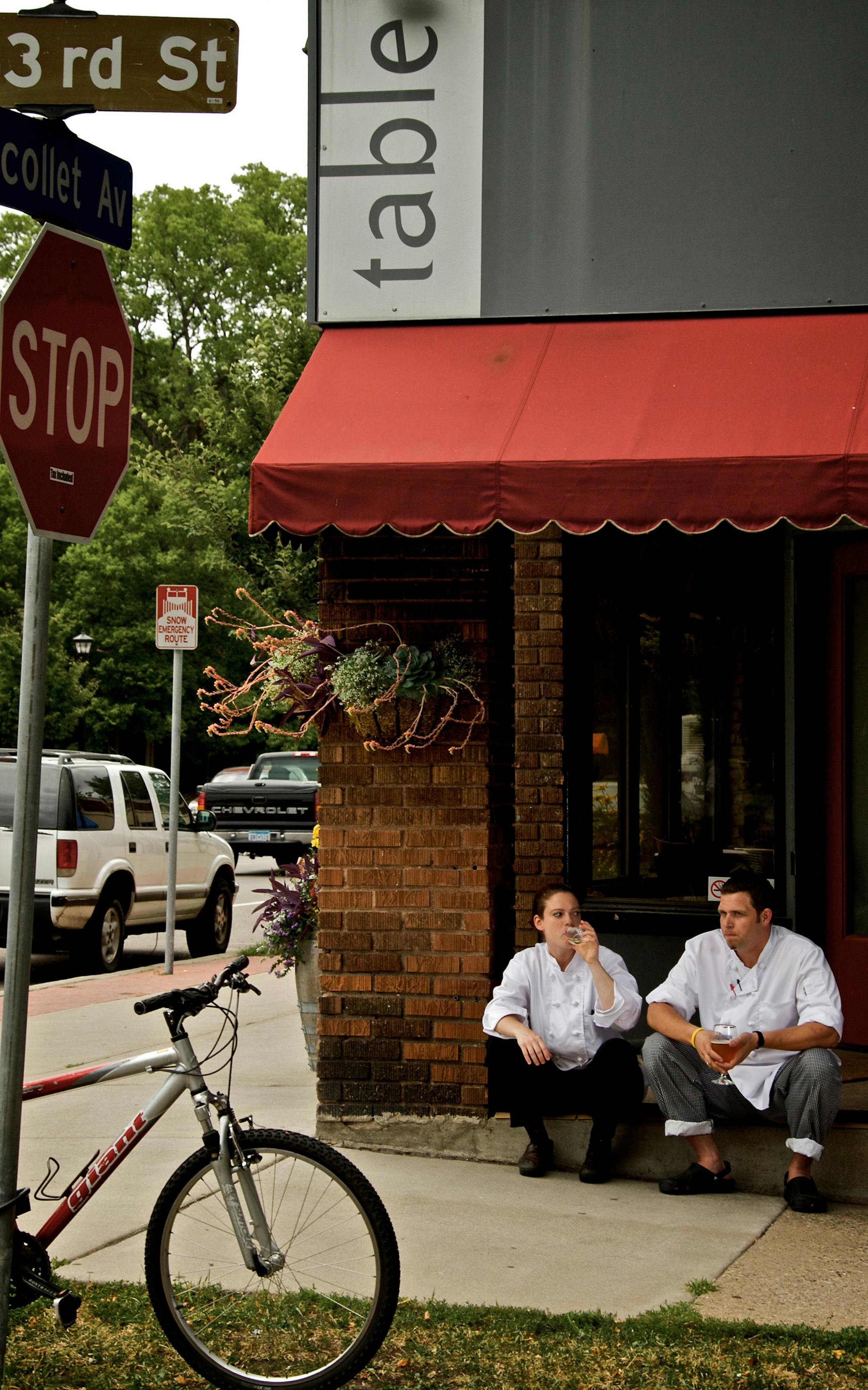 At the end of the day, after all their guests have gone home, Lida Hanson, chef de cuisine, left, and Scott Pampuch, chef, sit on the front steps of the Corner Table and have a glass of wine or beer.