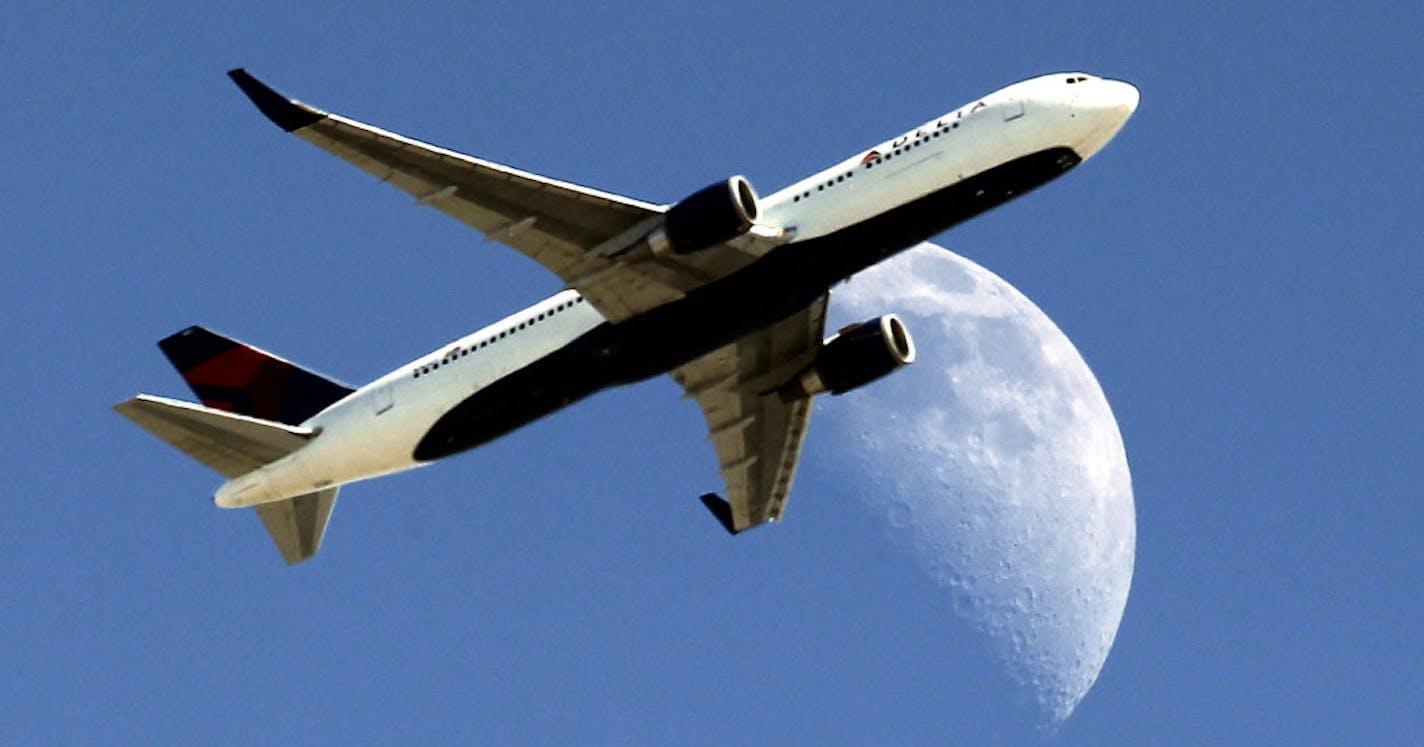 Delta Airlines flight DL370 from Managua Nicaragua crosses over a waxing crescent moon as it passes over Whittier, Calif. on approach to the Los Angeles Airport (LAX) on Labor Day, Monday, Sept. 1, 2014. (AP Photo/ Nick Ut )