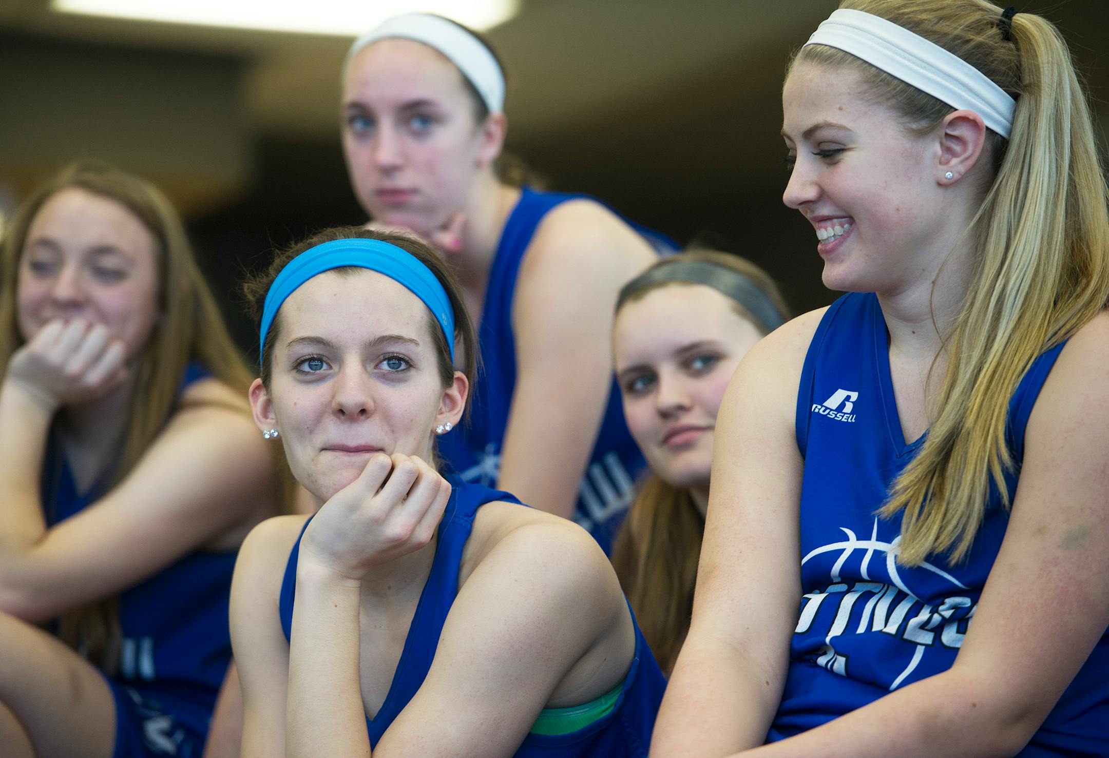 Members of the Eastview High School girls basketball team listen as coach Melissa Guebert speaks during a National Letter of Intent ceremony February 5, 2014