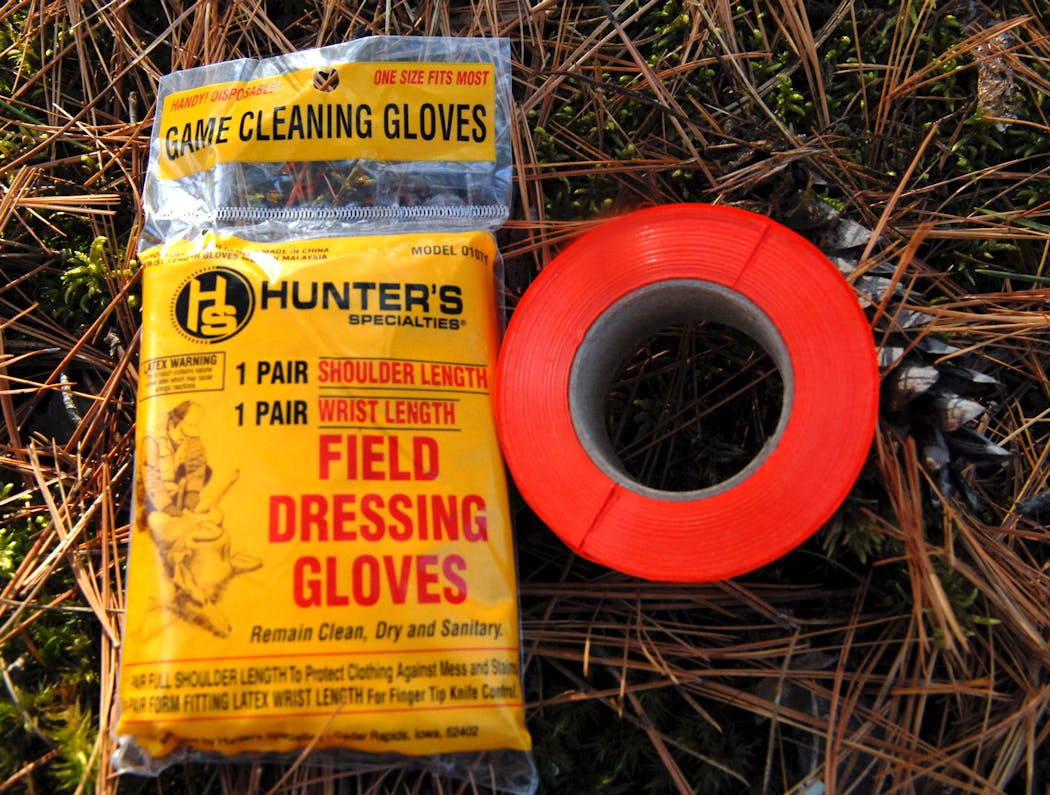 Handy to have in the field: Disposable field dressing gloves keep hunters clean, while trail marking tape can help hunters track deer.
