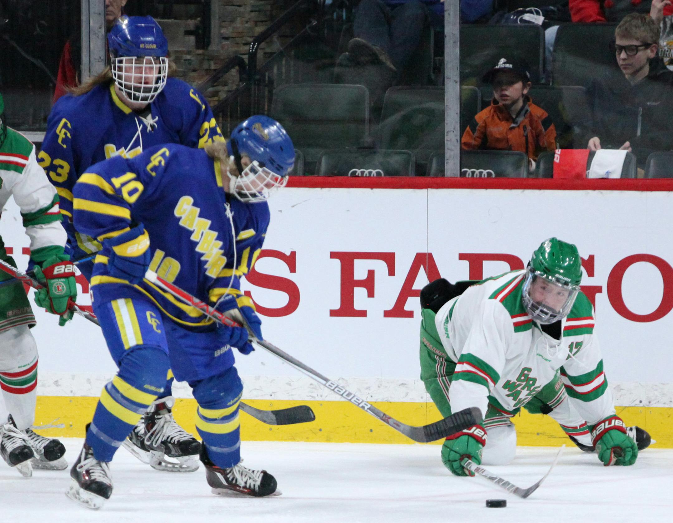 St. Cloud Cathedral's Jaron Hirschfeld (10) and East Grand Forks' Nick Derrick (17) chase the puck in the first period. ] XAVIER WANG • xavier.wang@startribune.com Game action from a class A Boys’ Hockey state tournament between St. Cloud Cathedral and East Grand Forks Wednesday. Mar, 8. 2017 at Xcel Energy Center in St. Paul, Minnesota.