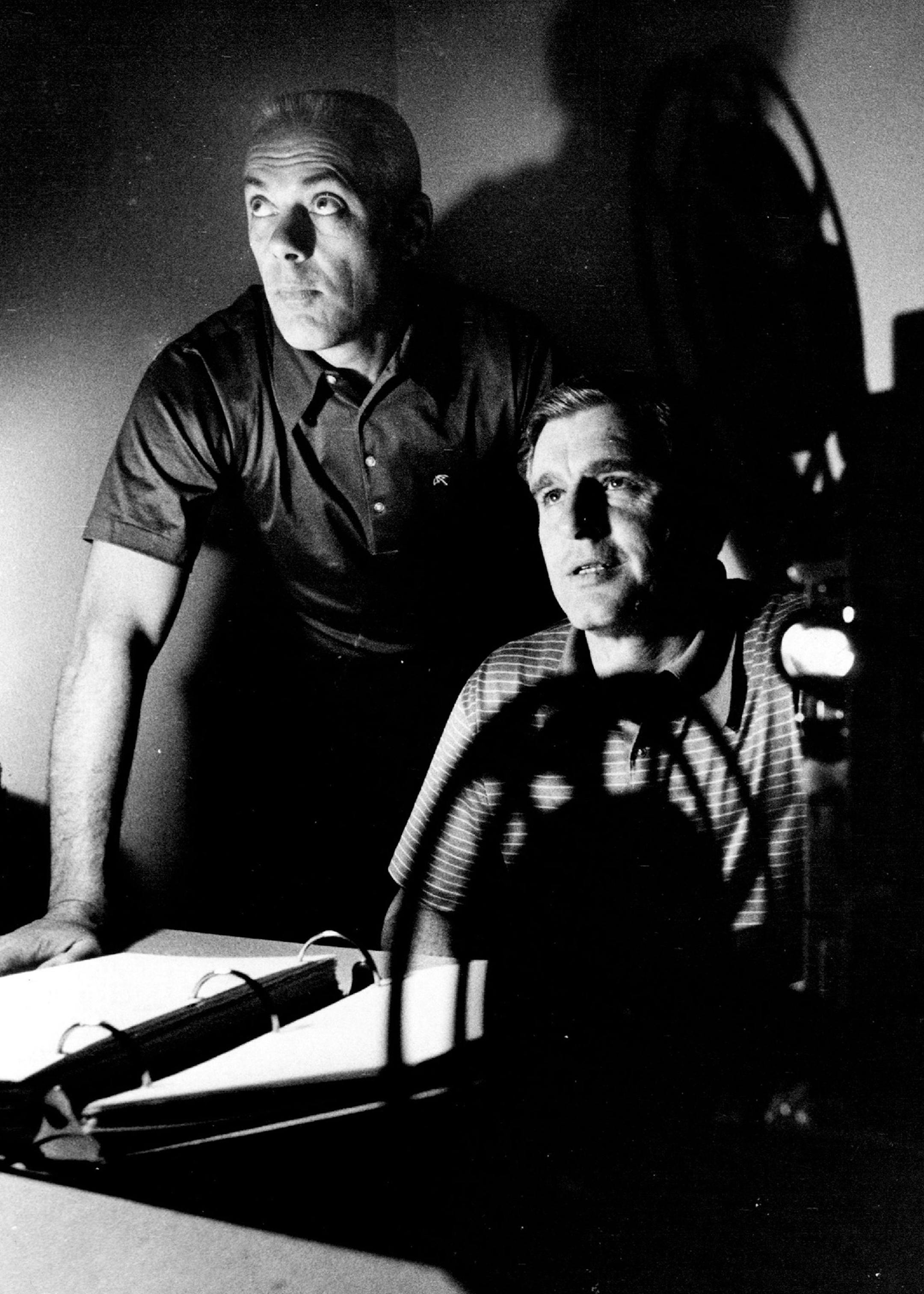 Neill Armstrong, right, Minnesota Vikings defensive coach, studied some films with head coach Bud Grant in 1971.