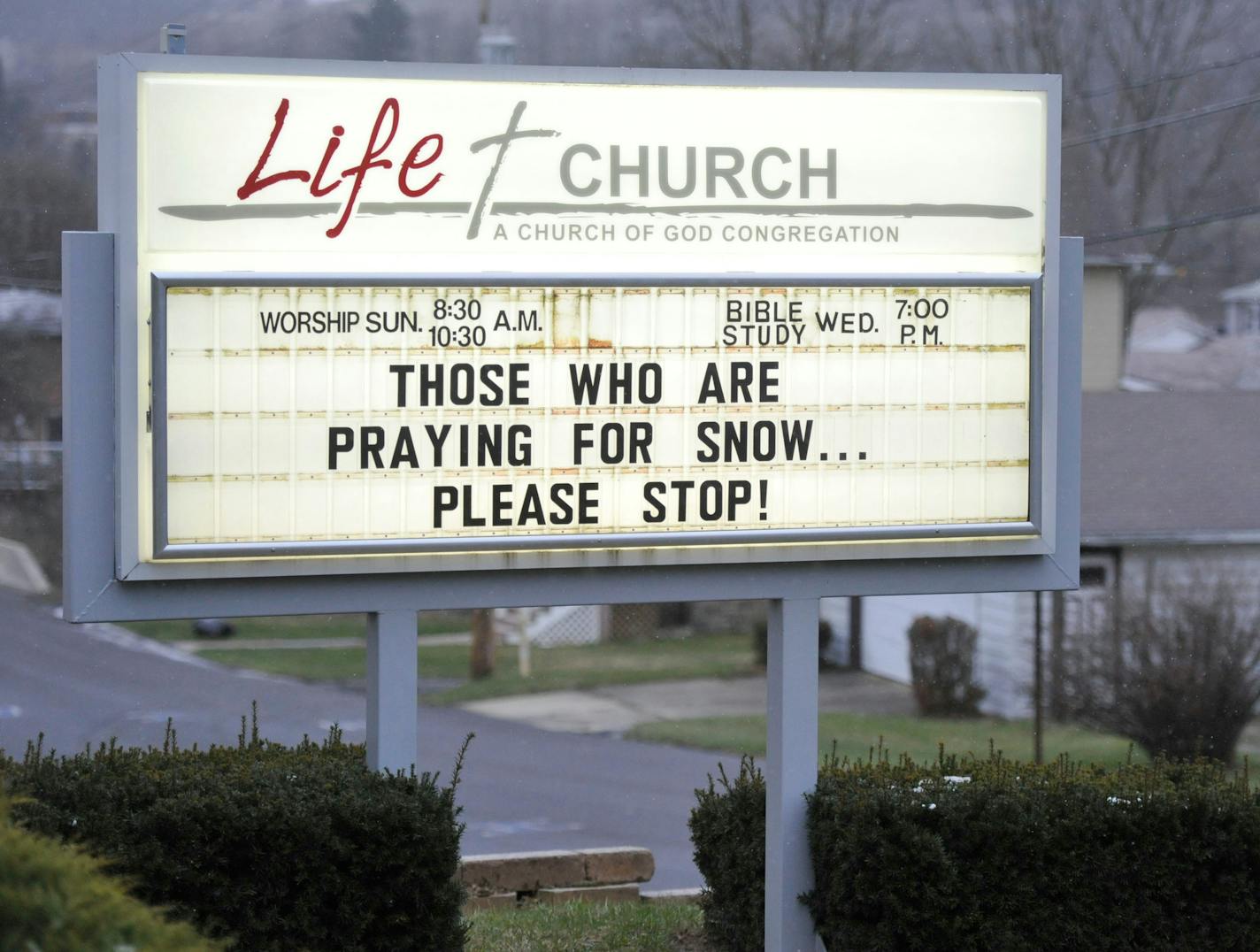 The Life Church, in Windber, Pa., message board requests passersby to stop praying for snow as snow flakes fall, Monday, April 9, 2018. (Todd Berkey/The Tribune-Democrat via AP)