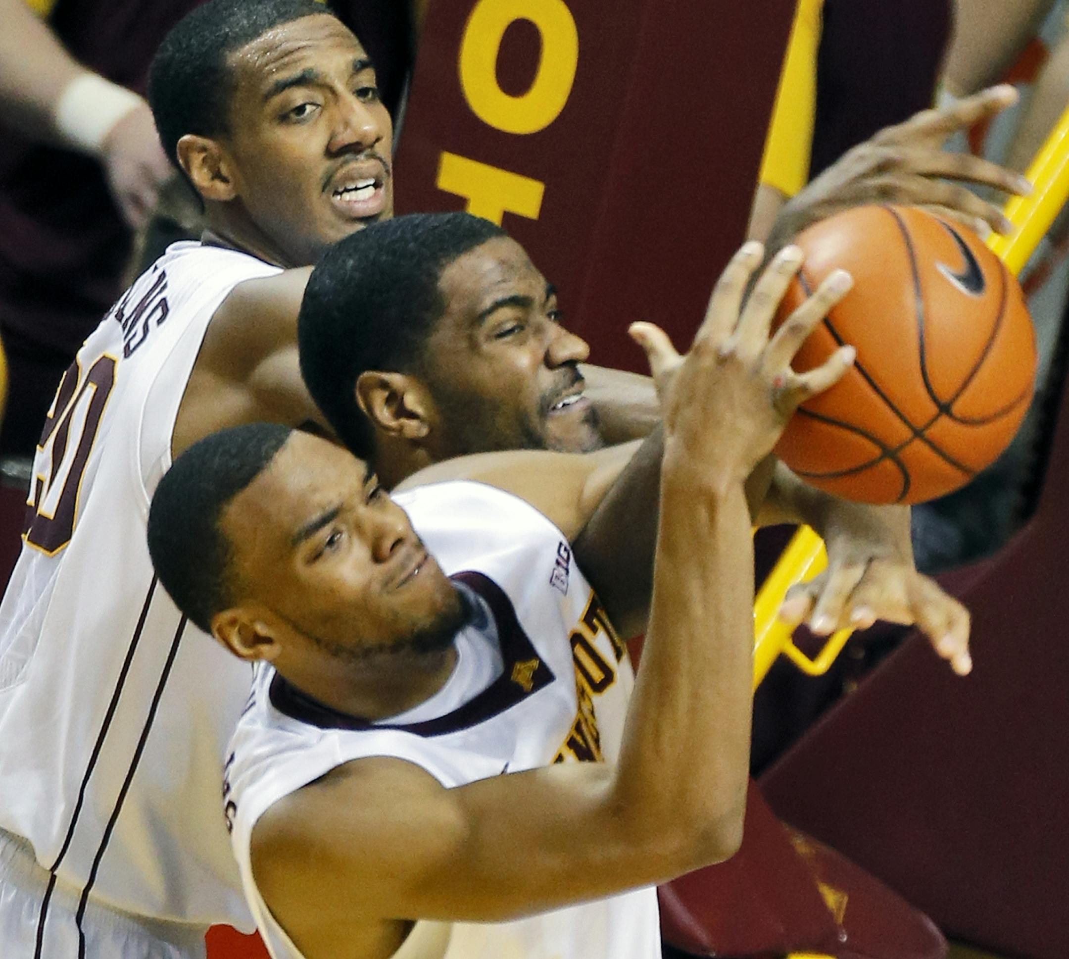 Minnesota Gophers mens basketball vs. Purdue. Minnesota won 82-79. Minnesota's Autin Hollins, top, and Andre Hollins, bottom, defensively sandwiched Purdue's Rapheal Davis as they controled a 2nd half rebound. (MARLIN LEVISON/STARTRIBUNE
