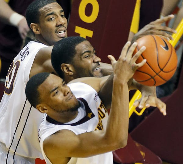 Minnesota Gophers mens basketball vs. Purdue. Minnesota won 82-79. Minnesota's Autin Hollins, top, and Andre Hollins, bottom, defensively sandwiched P