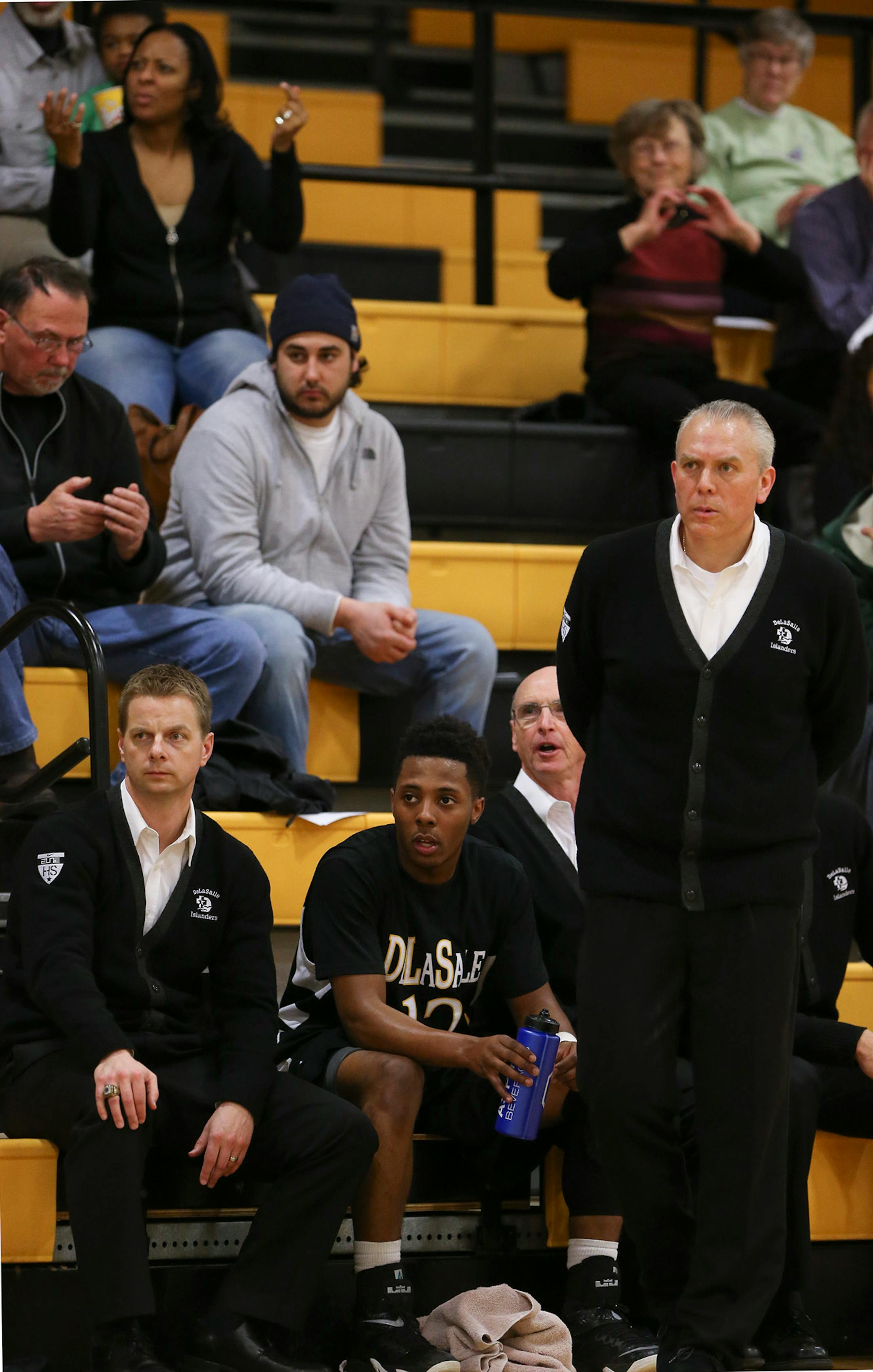DeLaSalle's Jarvis Johnson rested briefly on the bench in the first half near head coach Dave Thorson while his mother, Tanisha, gestured behind him the stands. ] JEFF WHEELER ï jeff.wheeler@startribune.com DeLaSalle High School trounced Fridley 69-31 in a boy's basketball game Thursday night, February 12, 2015 at DeLaSalle. The Islanders' Jarvis Johnson is the top preps hoops player in the state and the Gophers' No. 1 recruit for 2015.