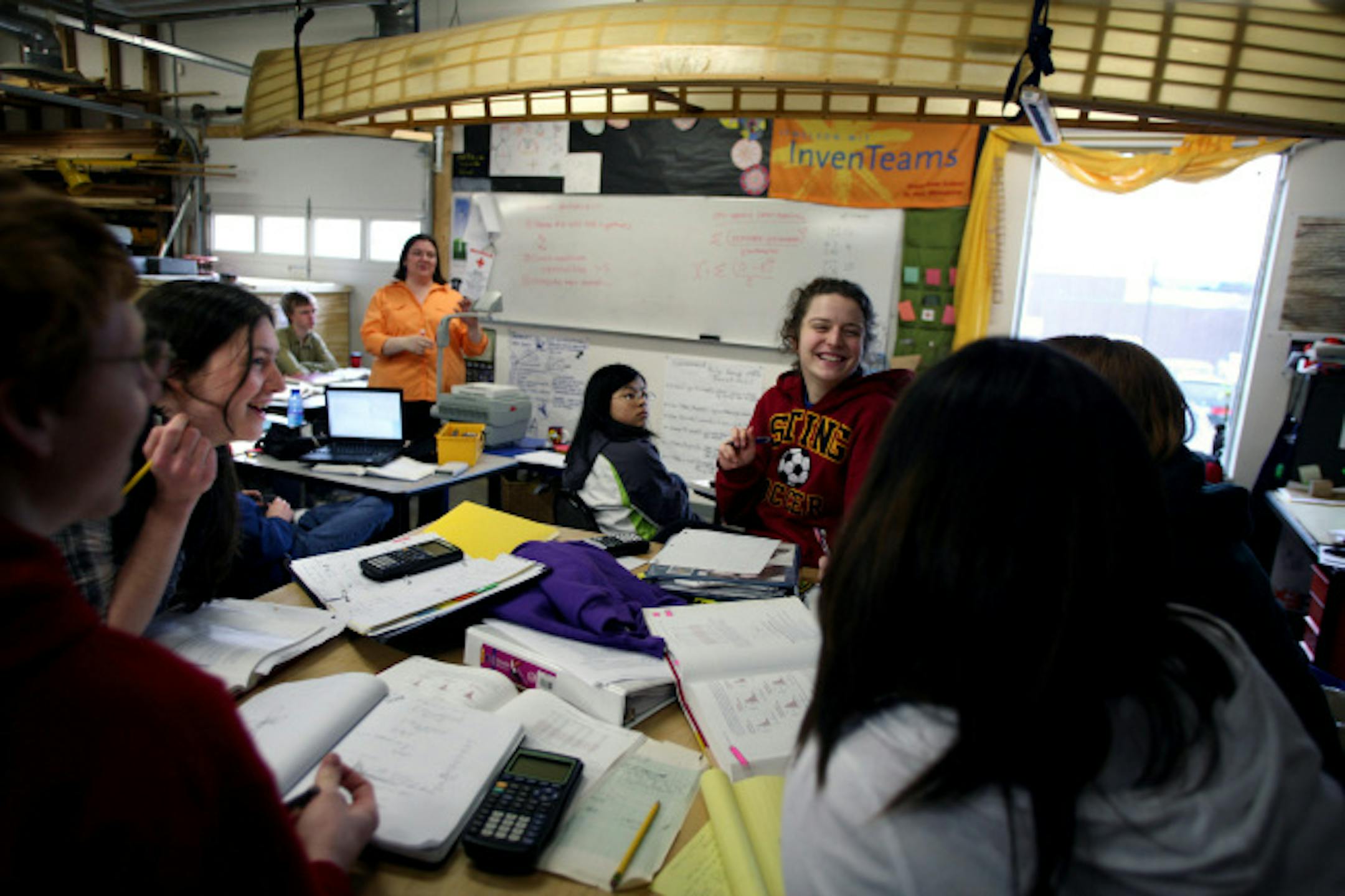 Students in teacher Kira Donnelly's class, including Andrew Orrison, Rebecca Orrison, Leah Brennan-Magidson, Susie Young-Townsend and Nora McConnell-Johnson seated at the table in the foreground, clockwise from left, talked through a statistics problem. The canoe hanging above the class was built by a small group of students during their J-term, a three week period in January in which students immerse themselves in a special project.