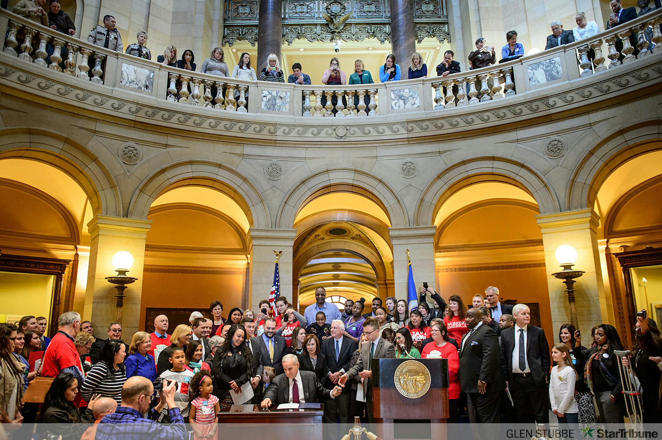Governor Mark Dayton signed the minimum wage bill into law at a public bill signing ceremony Monday the Minnesota State Capitol Rotunda.  The bill, which was passed by the Legislature last week, will increase Minnesota's minimum wage to $9.50 per hour, and index it to inflation.       ]   GLEN STUBBE * gstubbe@startribune.com   Monday, April 14, 2014