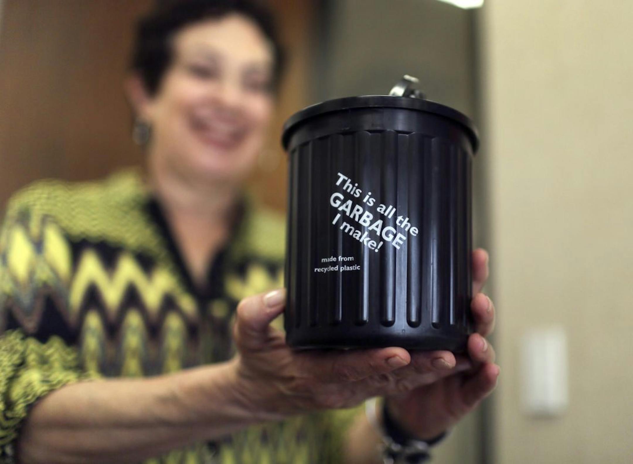 Judy Hollander, Hennepin County property services director, with the new mini-sized trash can distributed to Hennepin County Government Center employees this week and seen Wednesday, Sept 11, 2013, in Minneapolis, MN.