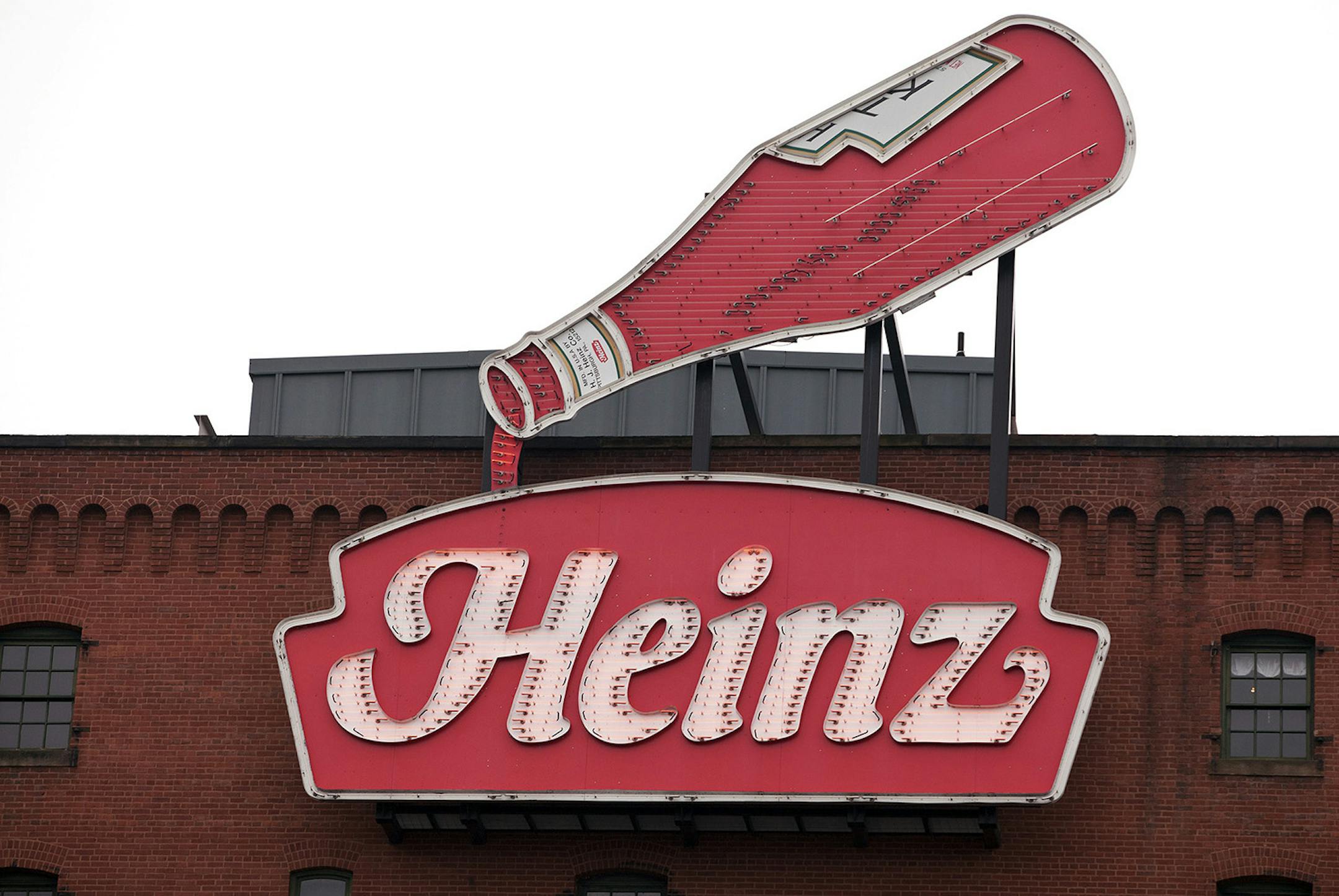 A sign advertises HJ Heinz Co. ketchup at the top of the Heinz History Center in Pittsburgh, Pennsylvania, U.S., on Thursday, Feb. 14, 2013. Warren Buffettís Berkshire Hathaway Inc. and Jorge Paulo Lemannís 3G Capital agreed to buy HJ Heinz Co. for about $23 billion, ending the independence of an iconic ketchup maker that traces its roots to the 1860s. Photographer: Kevin Lorenzi/Bloomberg ORG XMIT: 161818989
