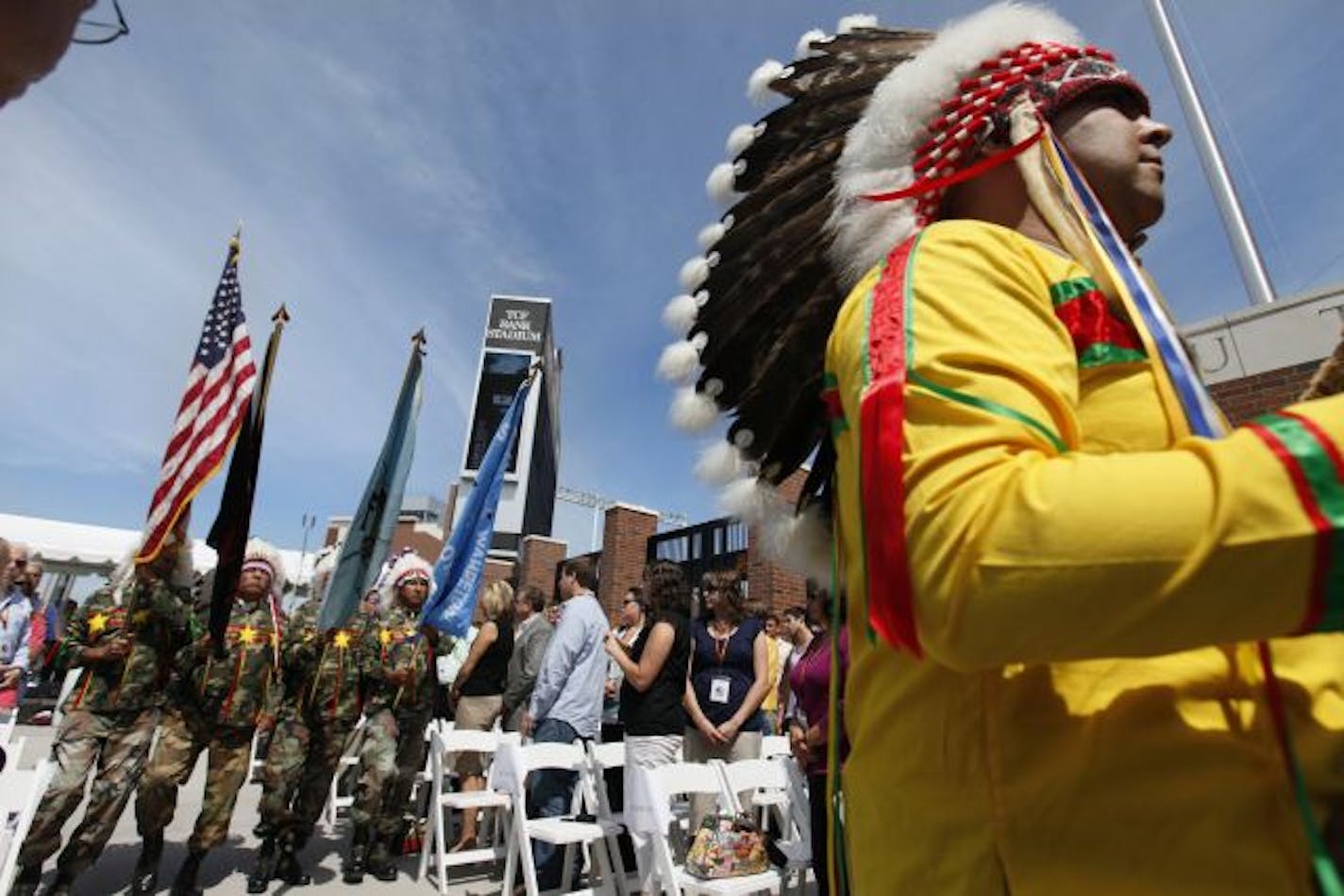 At the West entrance of TCF Stadium, members of the Sisseton Wahpeton Vietnam Veterans Association Kit Fox Society marched the flags in honor of a ceremony celebrating the Minnesota Tribal Nations Plaza. There are eleven markers on the plaza that pay tribute to the history of Native American tribes in the state. The Kit Fox Society is an honorary Vietnam veterans warrior club that includes Afghanistan veteran Dave Flute, far right, who just returned from Afghanistan as an army reserve in 82nd Ai