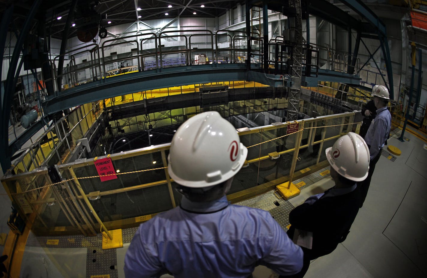 Xcel Energy employees examine a 38-foot-deep pool that holds spent fuel rods at its Monticello Nuclear Generating Plant. The utility said Monday it will seek to regulatory permission to extend the life of the plant, which is set to end in 2030, until at least 2040.