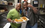 (Left) Stephan and Solomon Witherspoon posed for a portrait with their freshly fried up chicken at OMC Grill on Monday. ] ALEX KORMANN • alex.korman