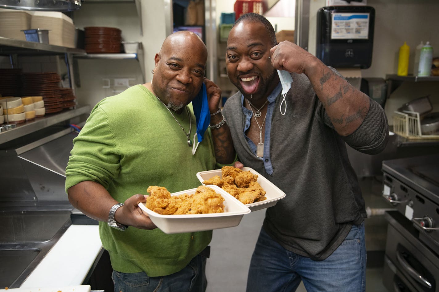 (Left) Stephan and Solomon Witherspoon posed for a portrait with their freshly fried up chicken at OMC Grill on Monday. ] ALEX KORMANN • alex.kormann@startribune.com Popular Duluth restaurant owner Tom Hanson is mentoring two lifelong locals who plan to eventually open their own soul food restaurant in the city's burgeoning Lincoln Park neighborhood.