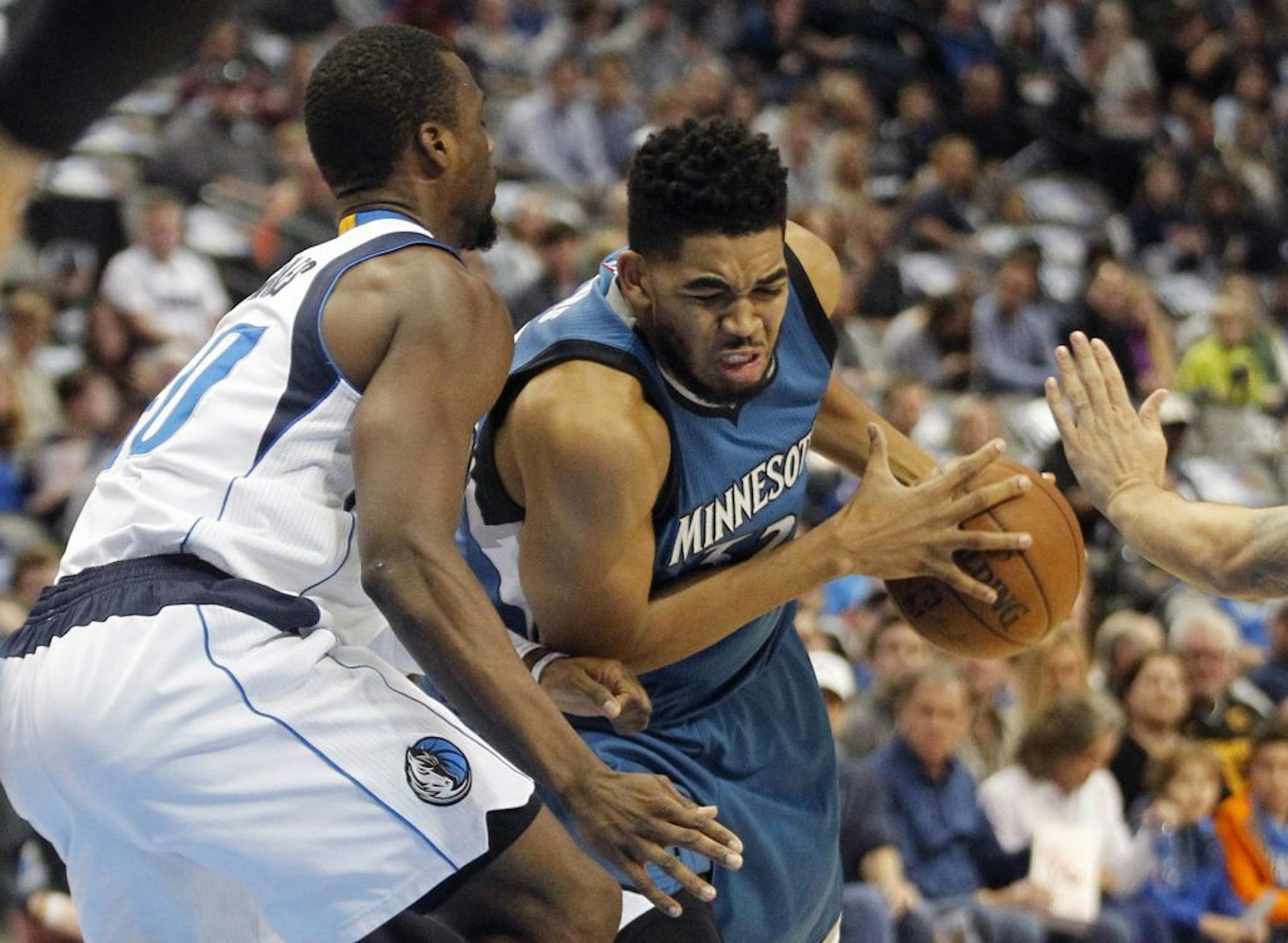Timberwolves center Karl-Anthony Towns, right, drove against Mavericks forward Harrison Barnes during the first half Sunday.