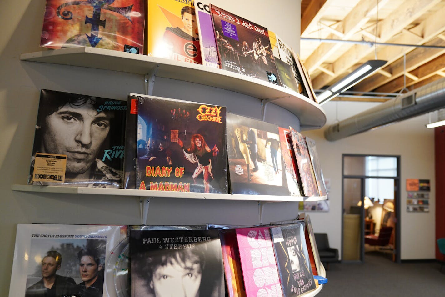 Some of Noiseland's new or catalog vinyl projects are displayed on the wall in the company's northeast Minneapolis offices.