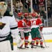 New Jersey Devils players celebrate a goal by Devante Smith-Pelly, center left, as Minnesota Wild goalie Darcy Kuemper skates away during the second p
