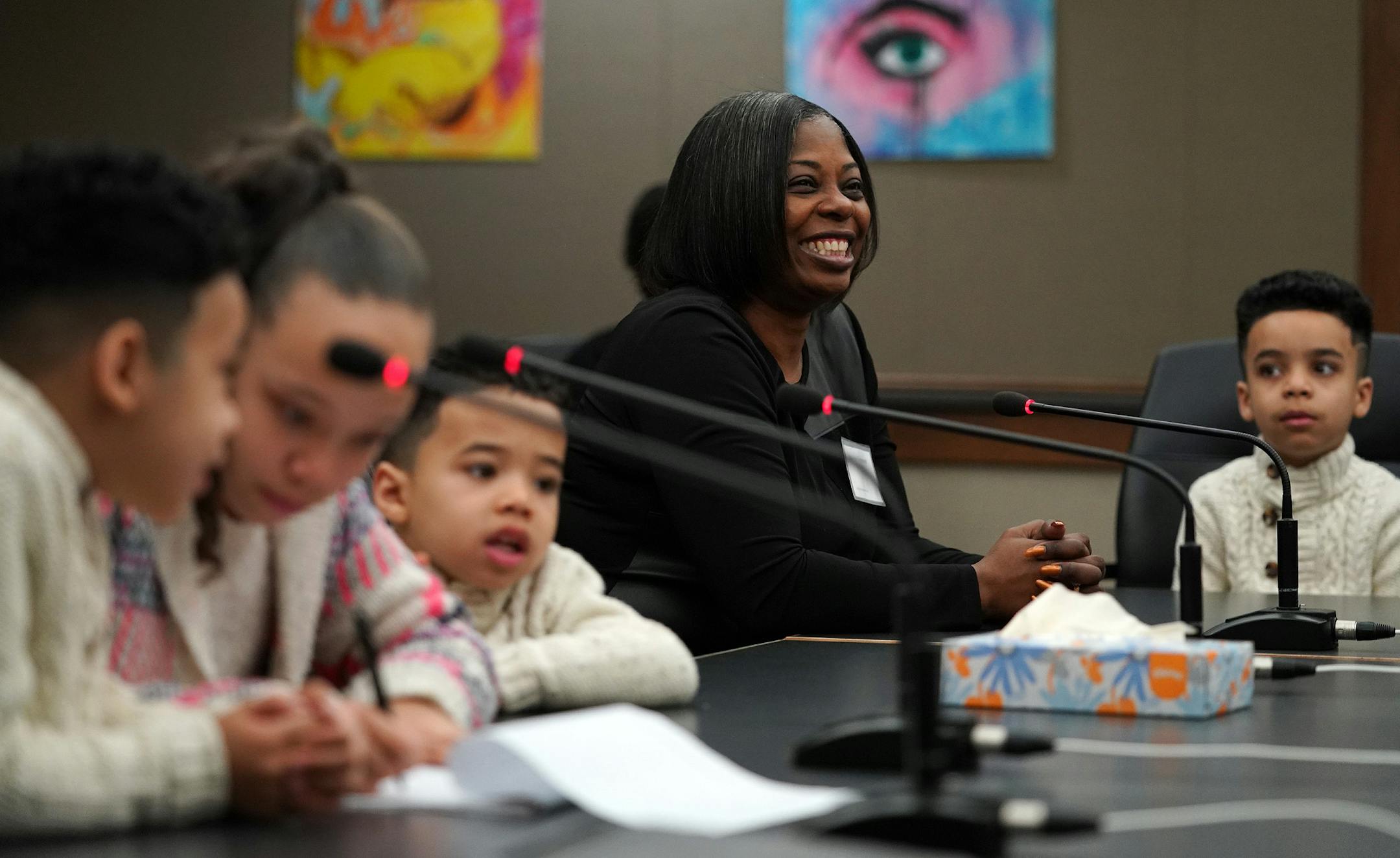 Malinda Gatewood, center, smiled as she sat with her niece Natilia, 10, and three nephews, from left, Jameson, 6, Tyrees, 4, and Andre, 8, during their adoption hearing Saturday morning. ] ANTHONY SOUFFLE ï anthony.souffle@startribune.com For National Adoption Day, 22 families finalized the adoption of almost 40 children Saturday, Nov. 17, 2018 at the Hennepin County Juvenile Justice Center in downtown Minneapolis.
