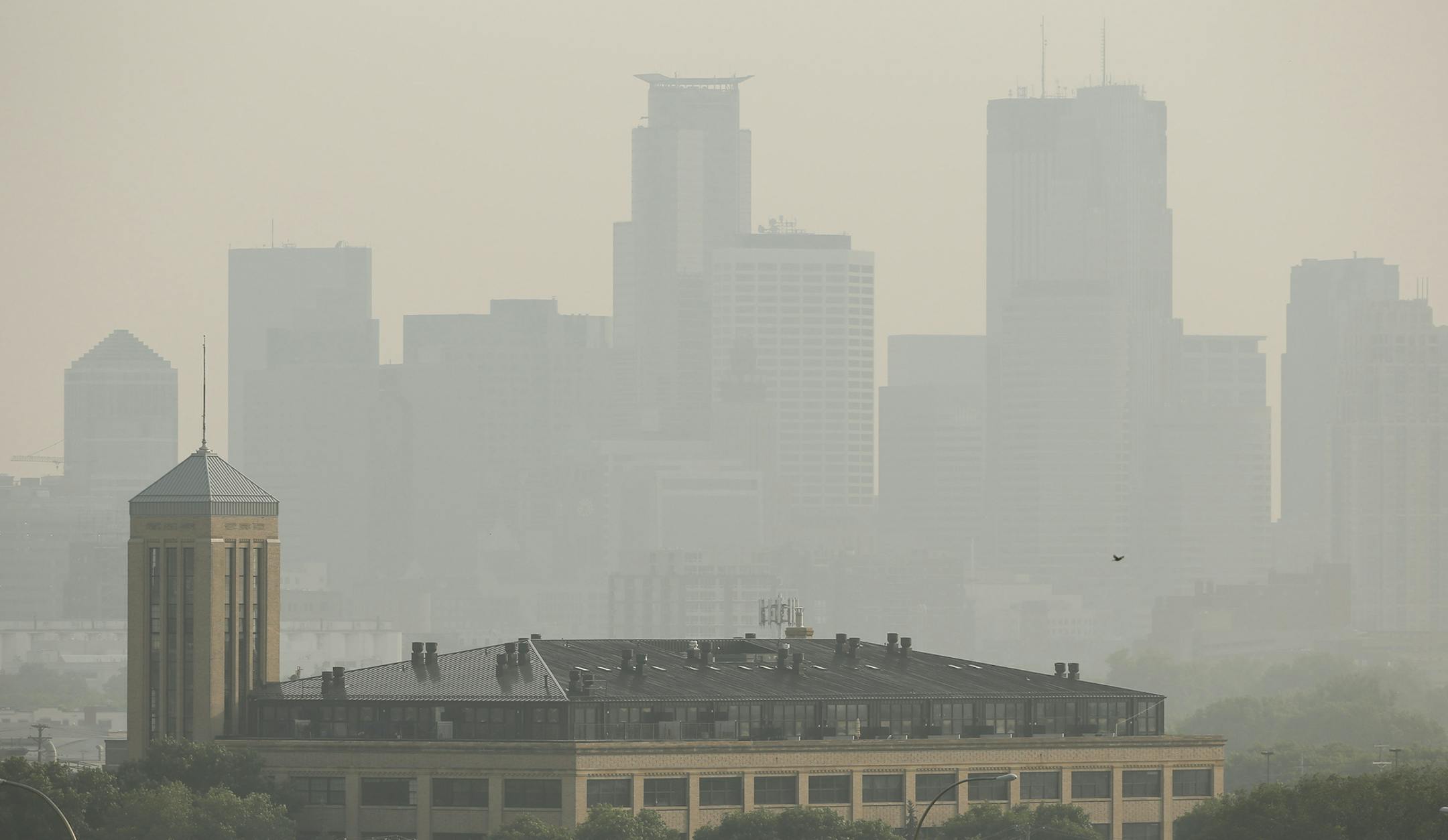 A haze rest along the Minneapolis skyline from the view of Ridgeway Parkway Park, Monday, July 6, 2015, in Minneapolis. The Minnesota Pollution Control Agency is expand its air pollution warning due to smoke from wildfires in Canada. The expanded area includes the Twin Cities. (Jeff Wheeler/Star Tribune via AP) MANDATORY CREDIT; ST. PAUL PIONEER PRESS OUT; MAGS OUT; TWIN CITIES LOCAL TELEVISION OUT ORG XMIT: MIN2015070621175174