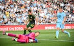 Portland Timbers goalkeeper Aljaz Ivacic (31) broke up a scoring attempt by Minnesota United midfielder Robin Lod (17) in the Loons’ 2-1 victory on 