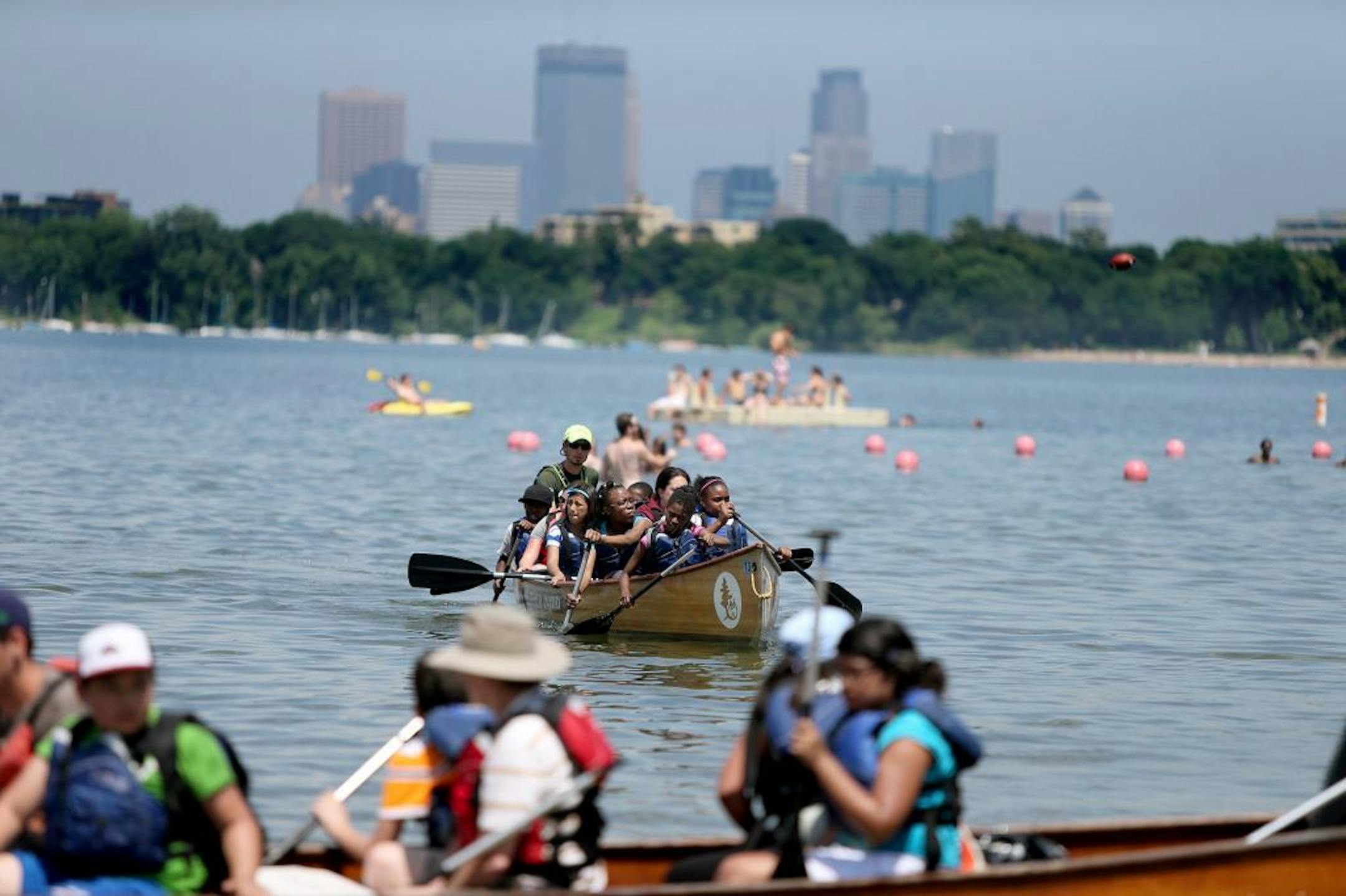 Lake Calhoun visitors kept cool in the lake by swimming, canoeing, and lounging as the air hovered over Minneapolis, Monday, July 8, 2013.