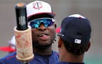 The Minnesota Twins Miguel Sano, left, chats with teammate Jorge Polanco while waiting to get in the cage for batting practice before the start of the