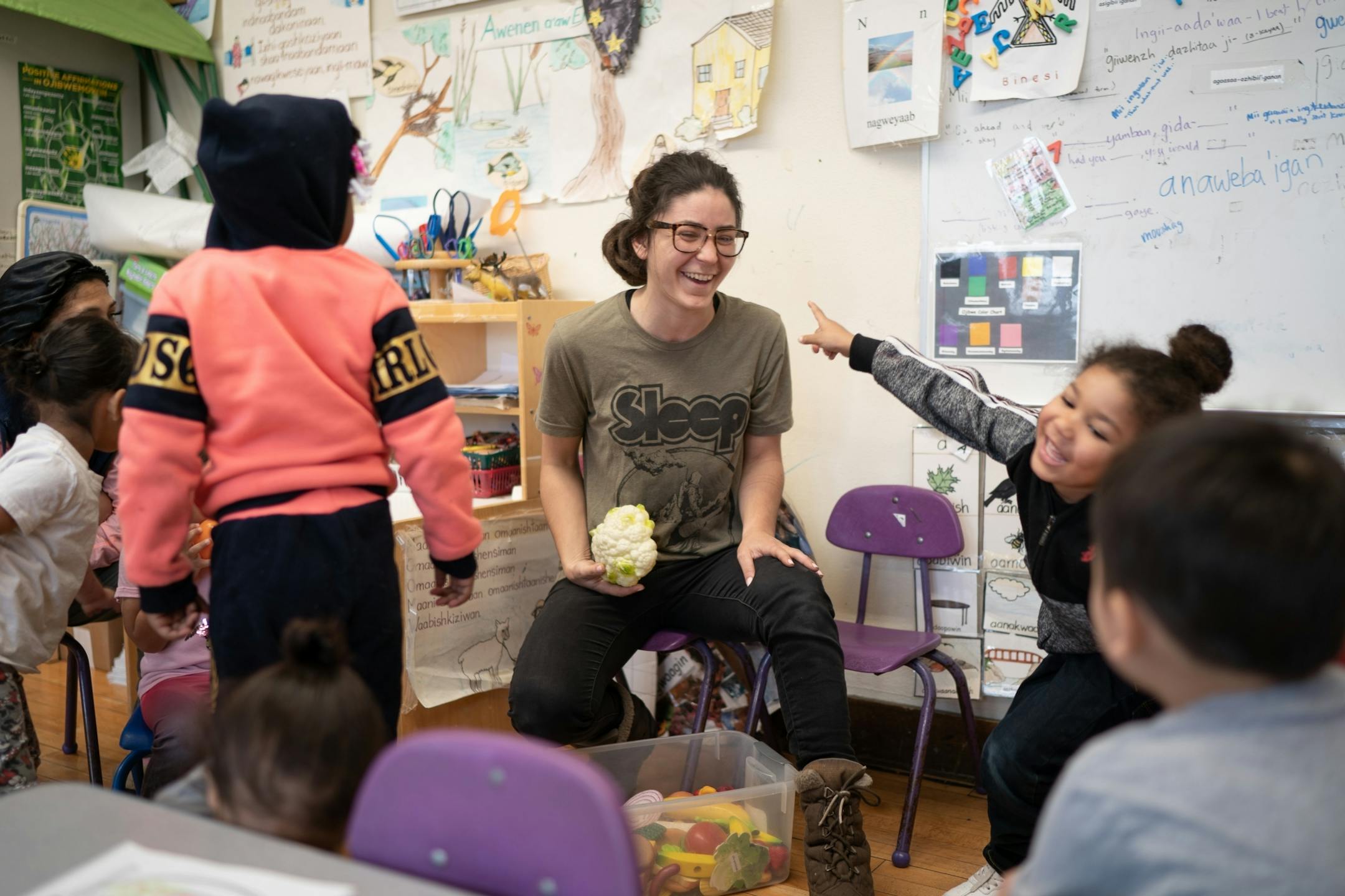 Ojibwe teacher Liz Zoongwegiizhigook Zinsli led an Ojibwe immersion class for students from 18 months to 5 years old, at Four Directions school. This week's theme was food groups where students named common foods speaking Ojibwe.