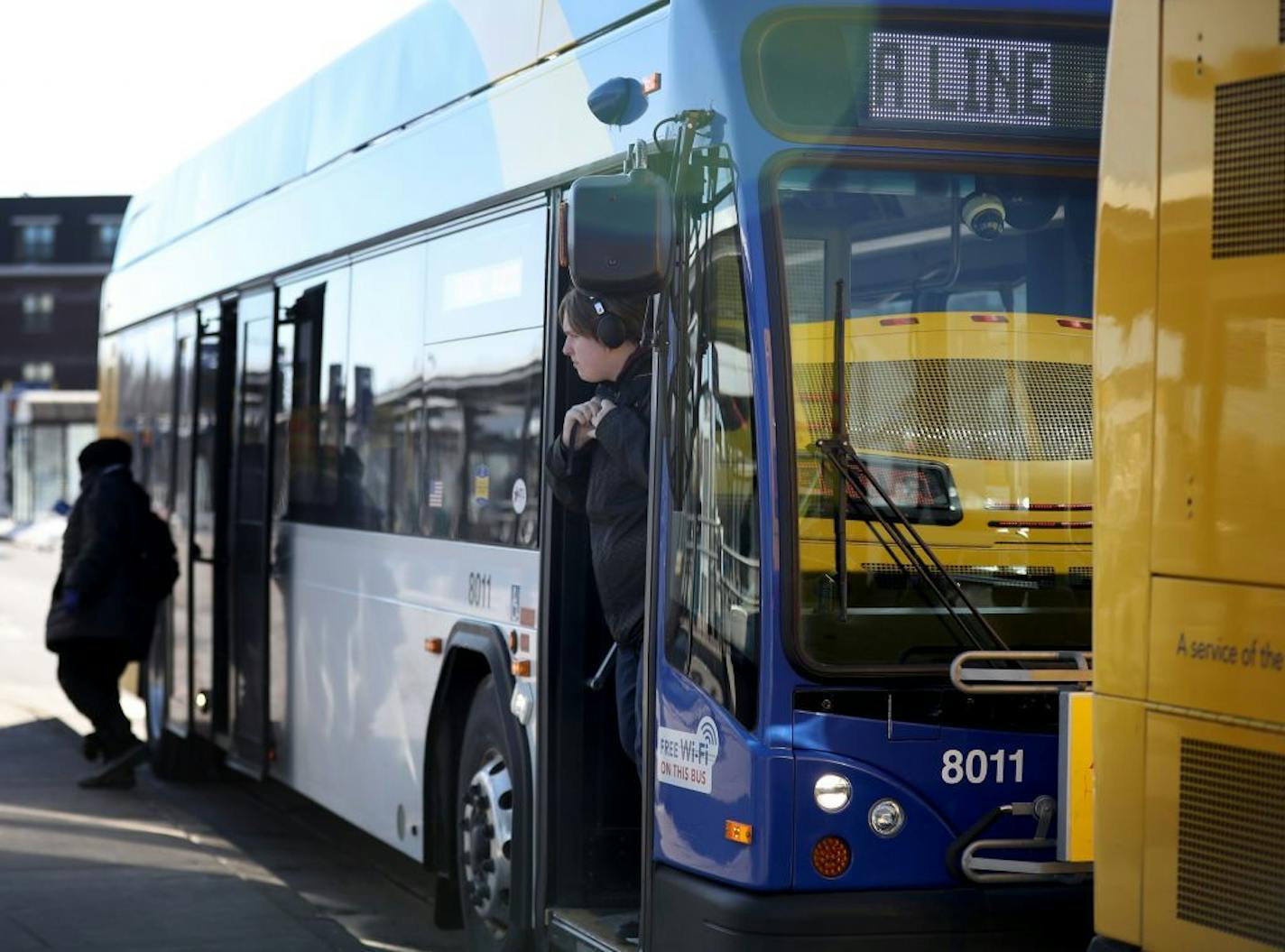 Riders disembark the A-Line bus at the 46th Street Blue Line LRT station.