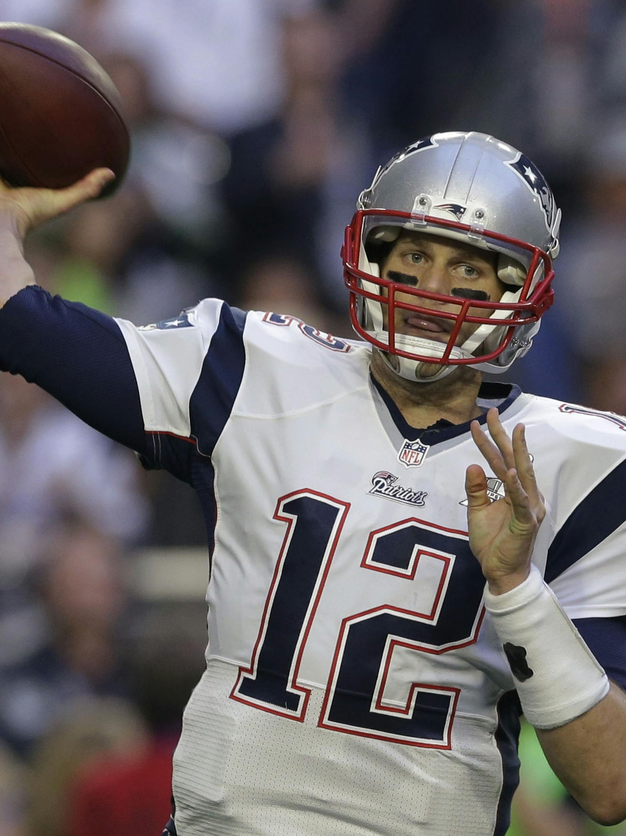 FILE - In this Sunday, Feb. 1, 2015 file photo, New England Patriots quarterback Tom Brady (12) passes against the Seattle Seahawks during the first half of NFL Super Bowl XLIX football game in Glendale, Ariz. Without the games to distract from the issues, football fans were left to ponder the NFL's policies, its commissioner and its overall credibility during an uncomfortable offseason for the league. Tom Brady and the Patriots got a favorable ruling from a New York judge, meaning the quarterba