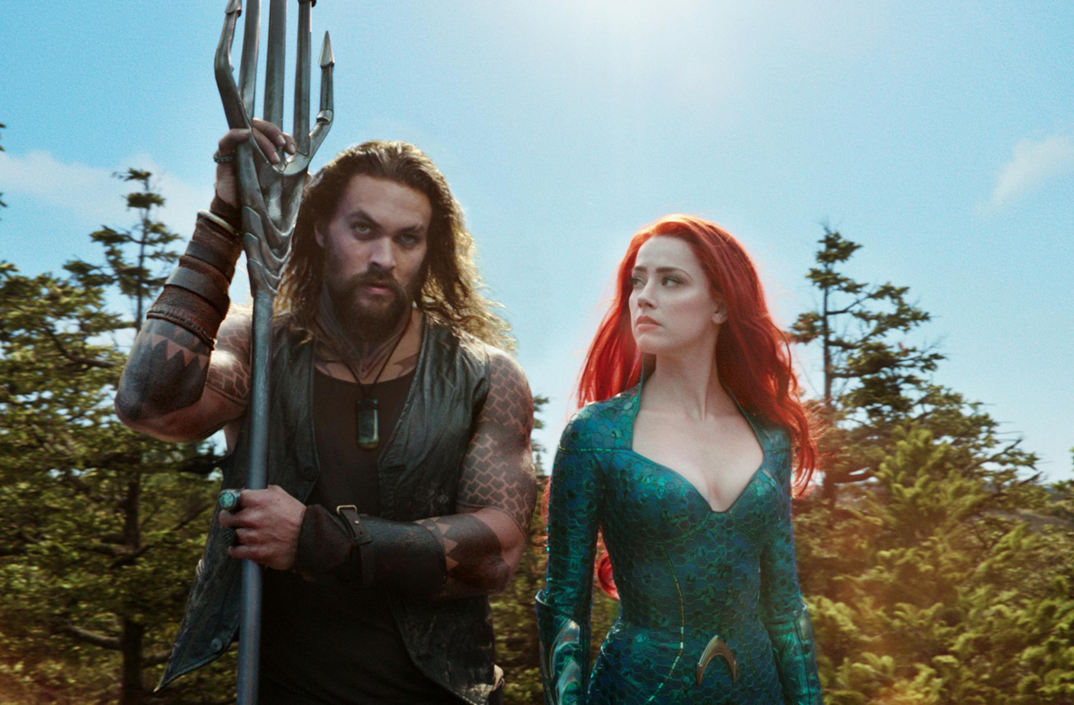 This image released by Warner Bros. Pictures shows Jason Momoa, left, and Amber Heard in a scene from "Aquaman." (Warner Bros. Pictures via AP)