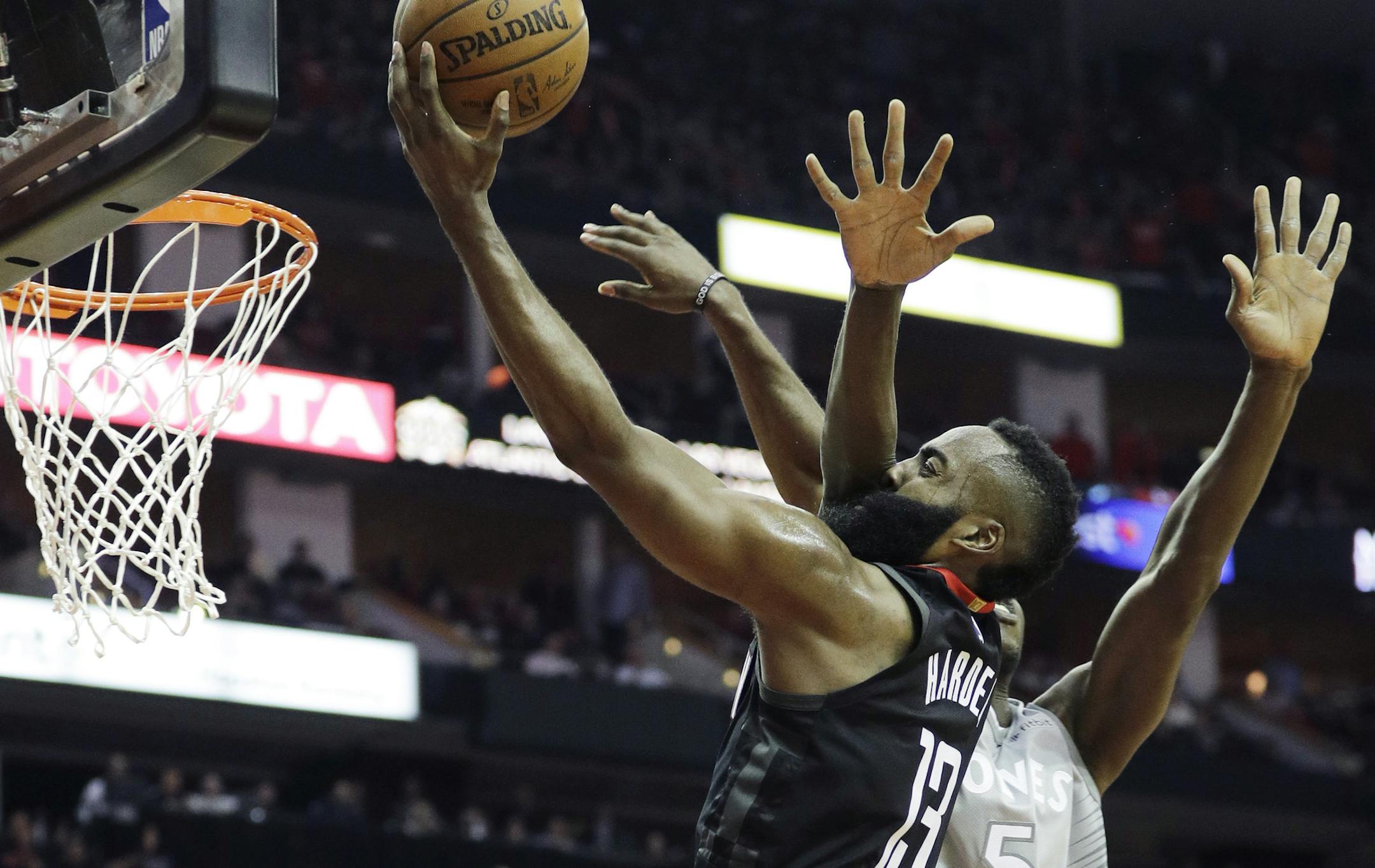 Minnesota Timberwolves' Gorgui Dieng, right, fouls Houston Rockets' James Harden during the second half in Game 1 of a first-round NBA basketball playoff series Sunday, April 15, 2018, in Houston. (AP Photo/David J. Phillip)