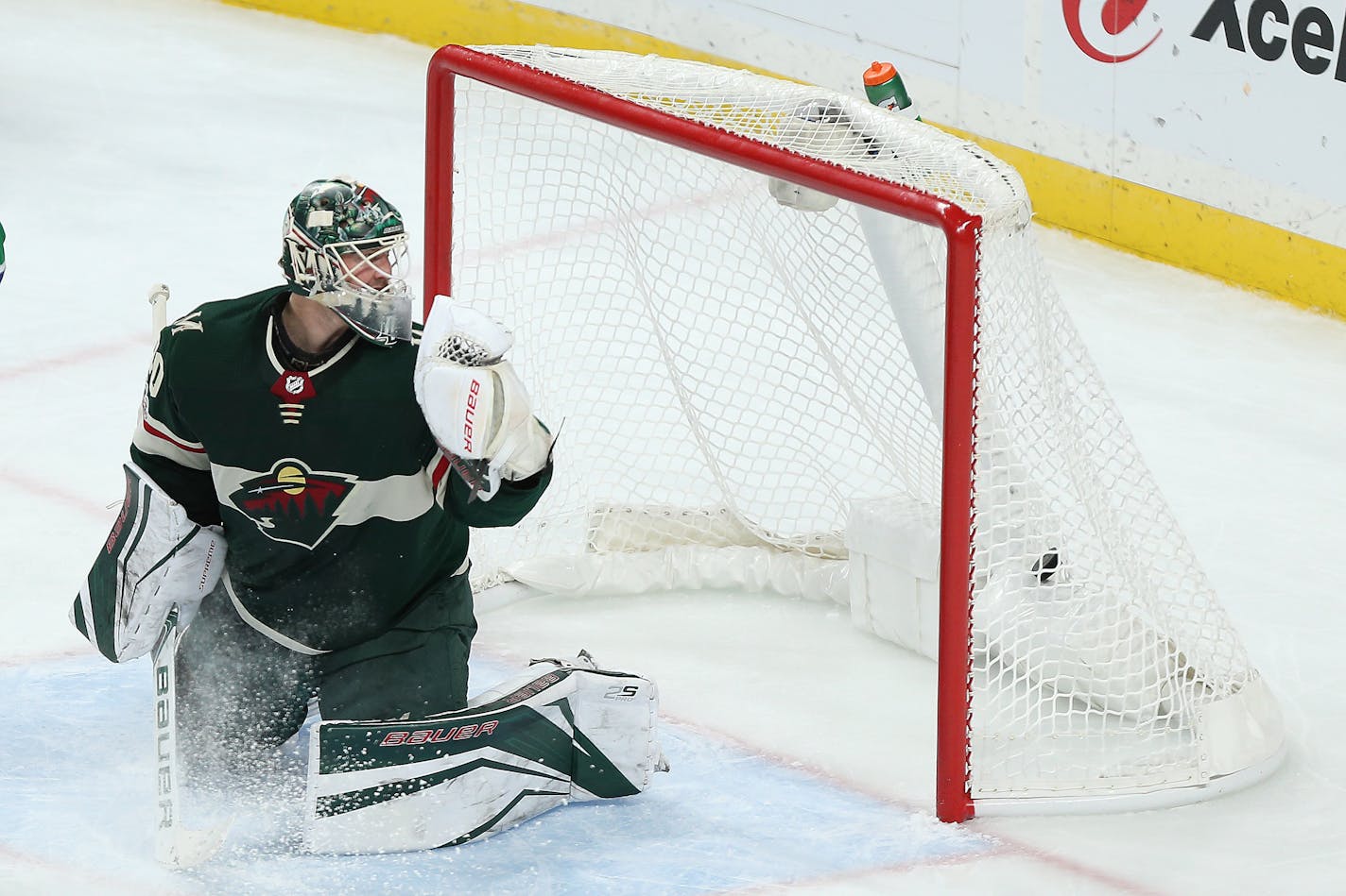 Devan Dubnyk looks back at the puck in the net after the Vancouver Canucks scored a goal in the third period