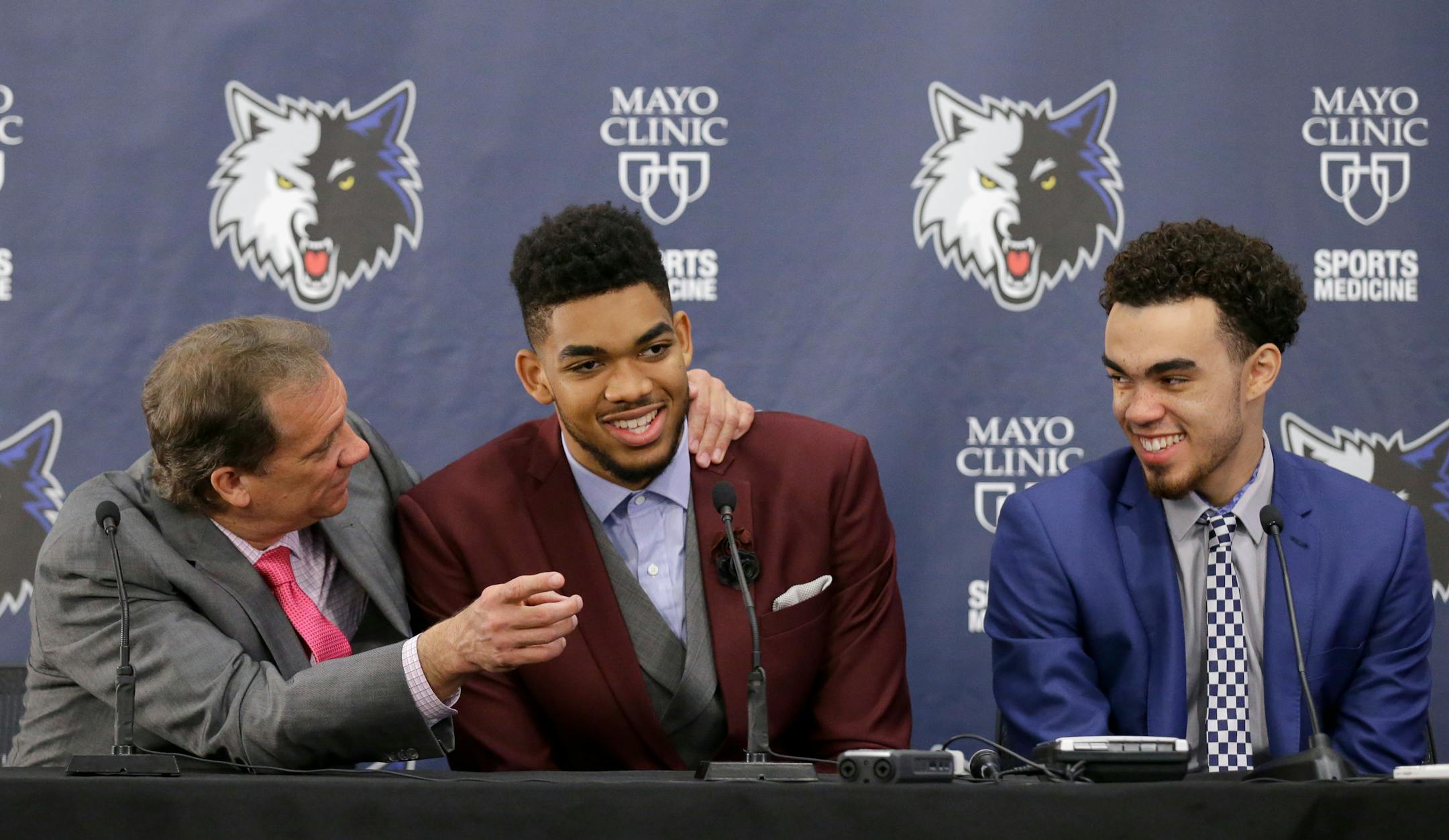 Minnesota Timberwolves draft picks Karl-Anthony Towns, center, and Tyus Jones, right, share a laugh with Flip Saunders, left, during a news conference in Minneapolis.
