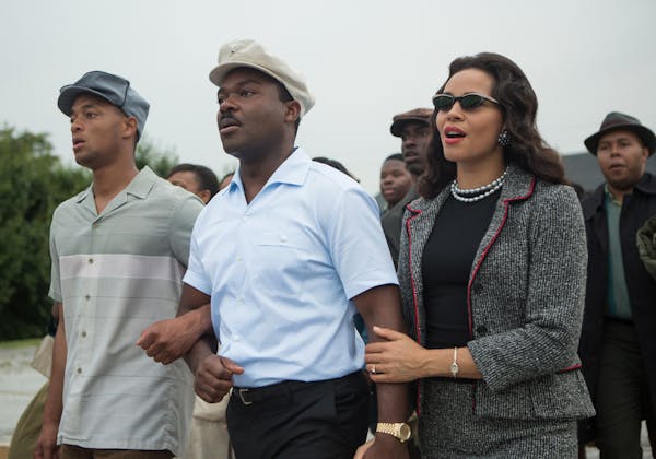 This photo released by Paramount Pictures shows, David Oyelowo, center, as Martin Luther King, Jr. and Carmen Ejogo, right, as Coretta Scott King in t