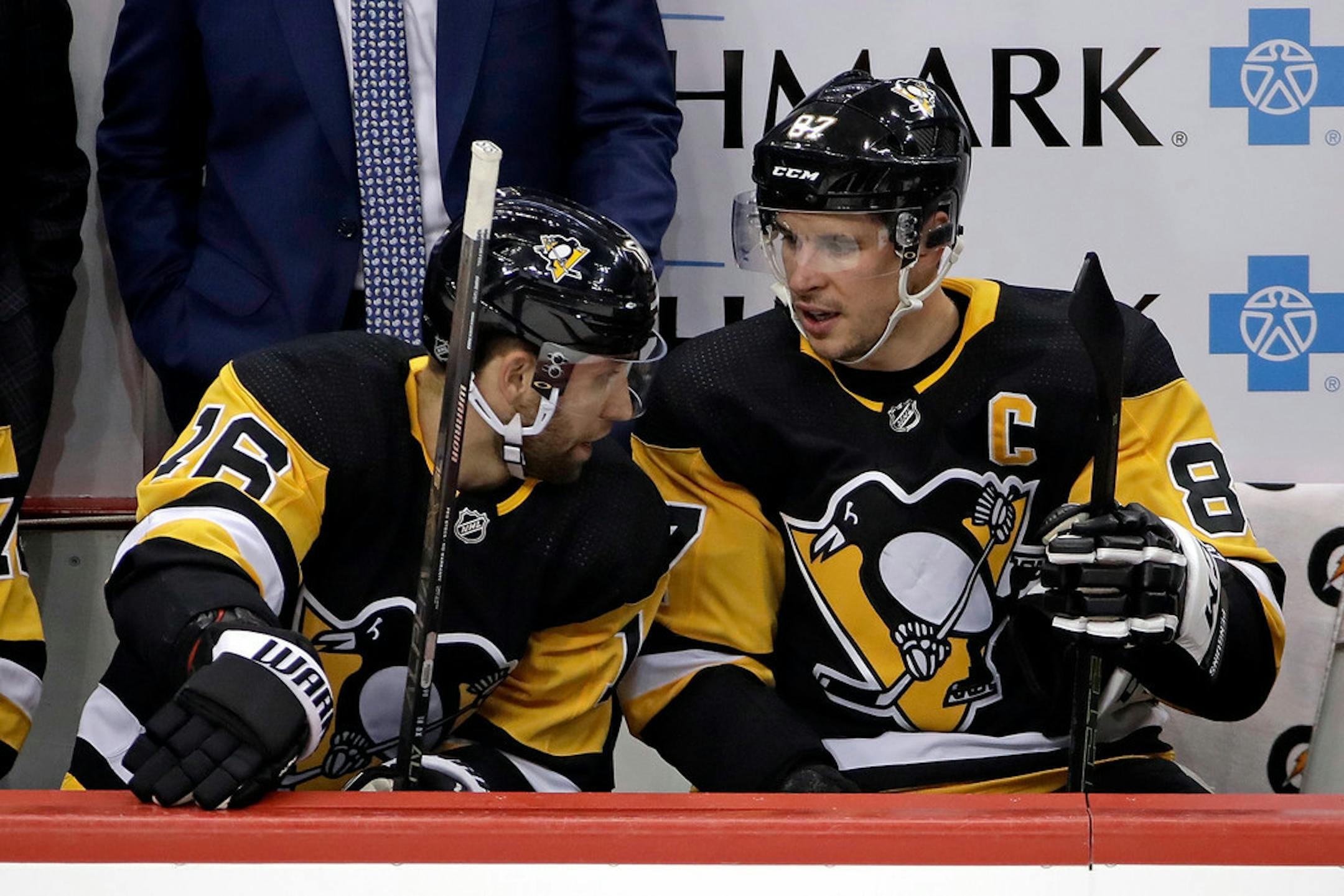 Pittsburgh Penguins' Sidney Crosby (87) talks with Jason Zucker (16) during the first period of an NHL hockey game against the Tampa Bay Lightning in Pittsburgh