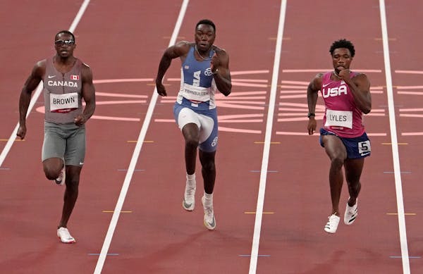 Hopkins’ Joe Fahnbulleh (center), running for Liberia, finished second in a men’s 200-meter semifinal. just behind Aaron Brown of Canada (left) an