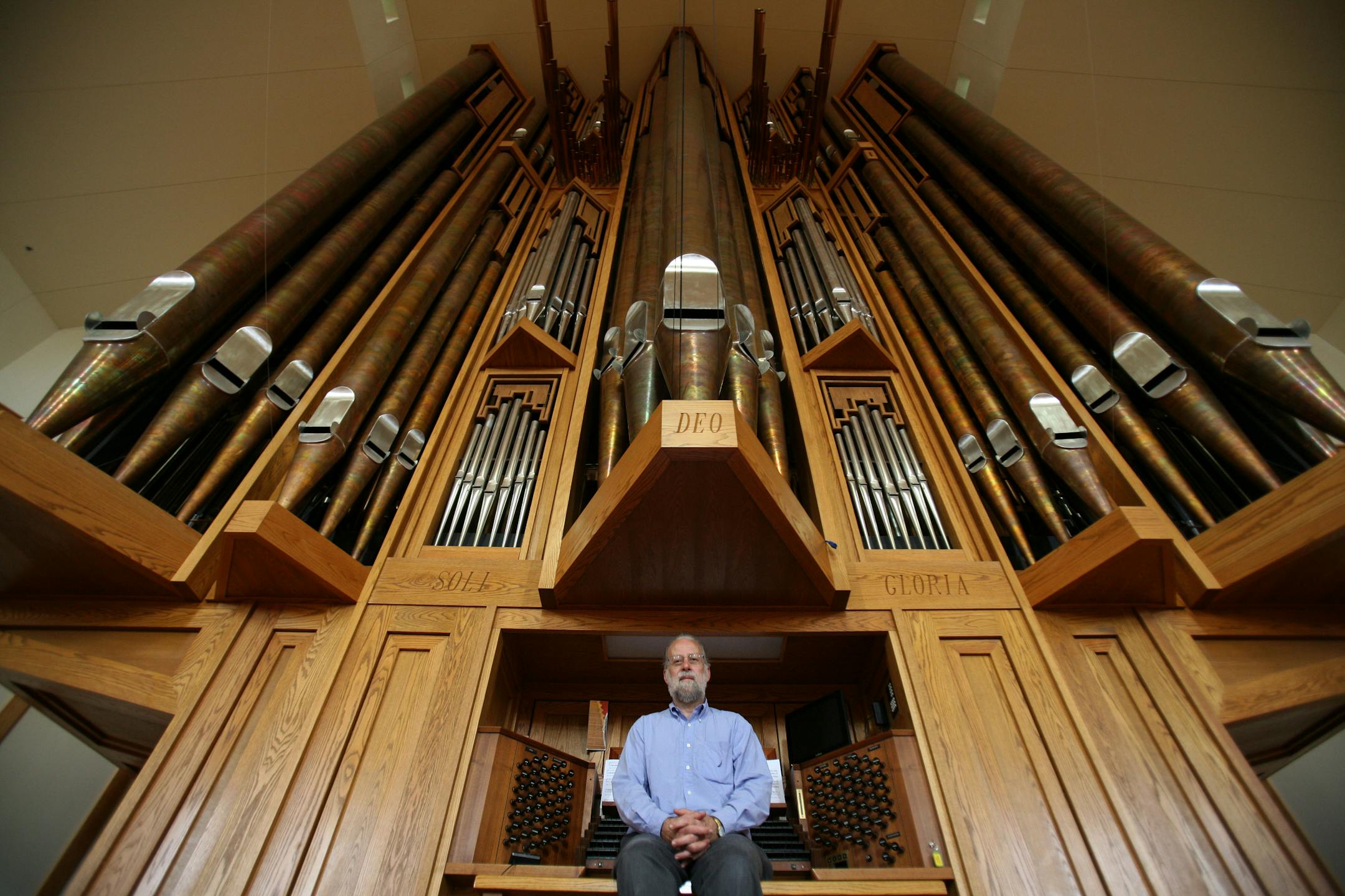 Michael Barone, host of public radio show called "Pipe Dreams", sat in front of the pipe organ at the Wooddale Church.
