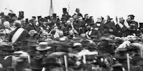 This Nov. 19, 1863 photo made available by the Library of Congress shows President Abraham Lincoln, center with no hat, surrounded by the crowd at the