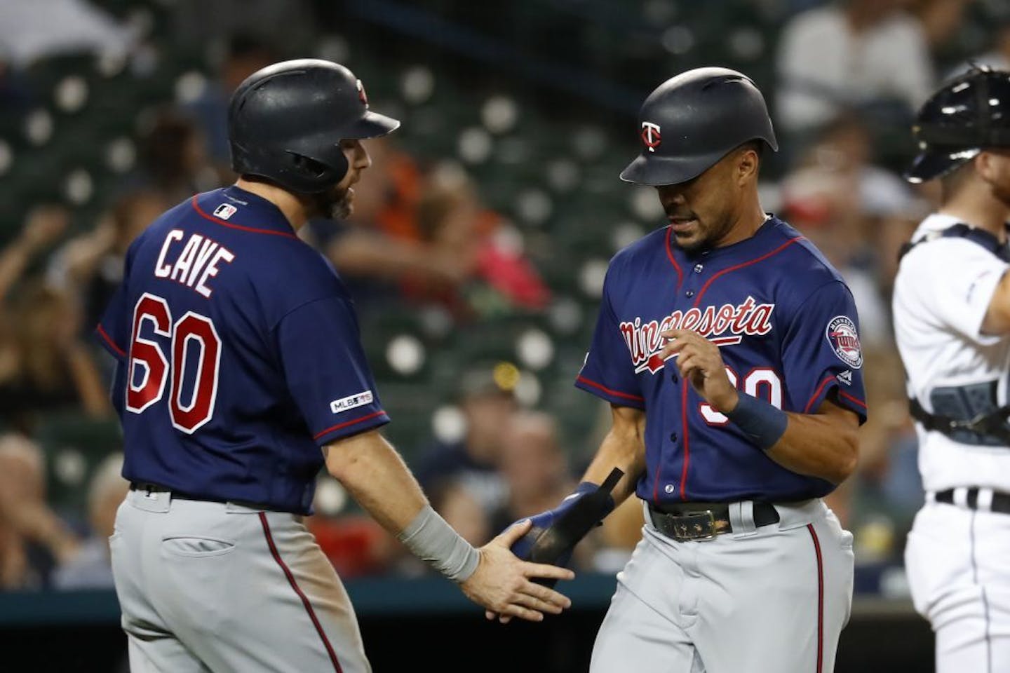 Jake Cave (left) congratulates LaMonte Wade Jr. during a game last season.