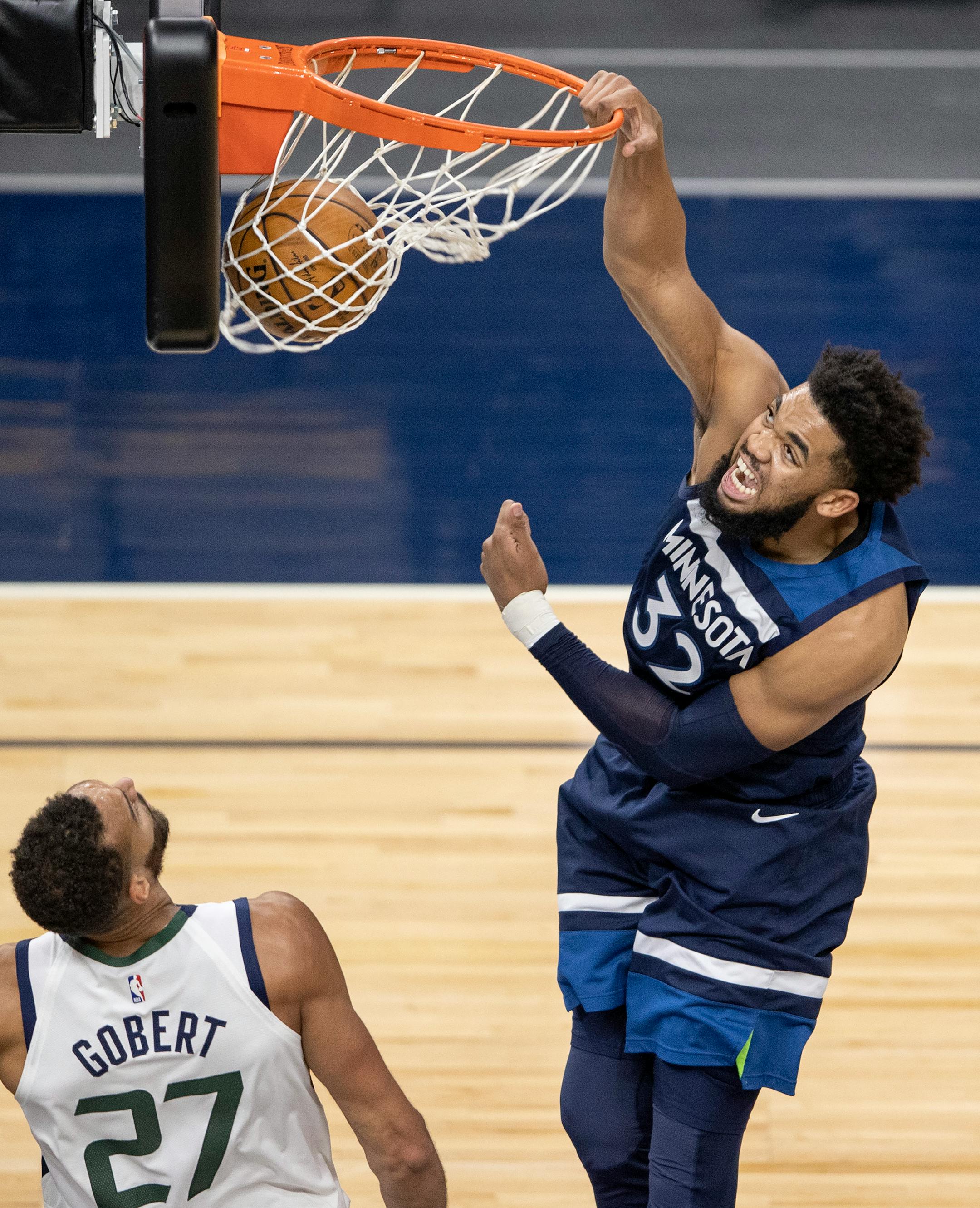 Karl-Anthony Towns (32) of the Minnesota Timberwolves dunked the ball next Rudy Gobert (27) of the Utah Jazz in the third quarter.