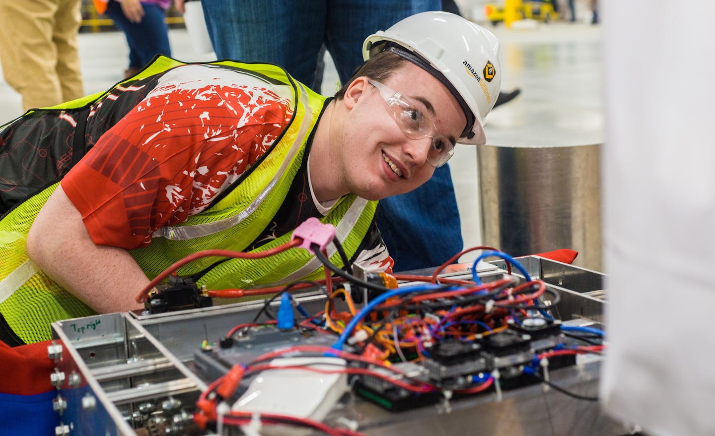 Scott Korum, senior at Shakopee Senior High School and members of Shakopee Robotics team, works on their personally designed robots in the not yet ope